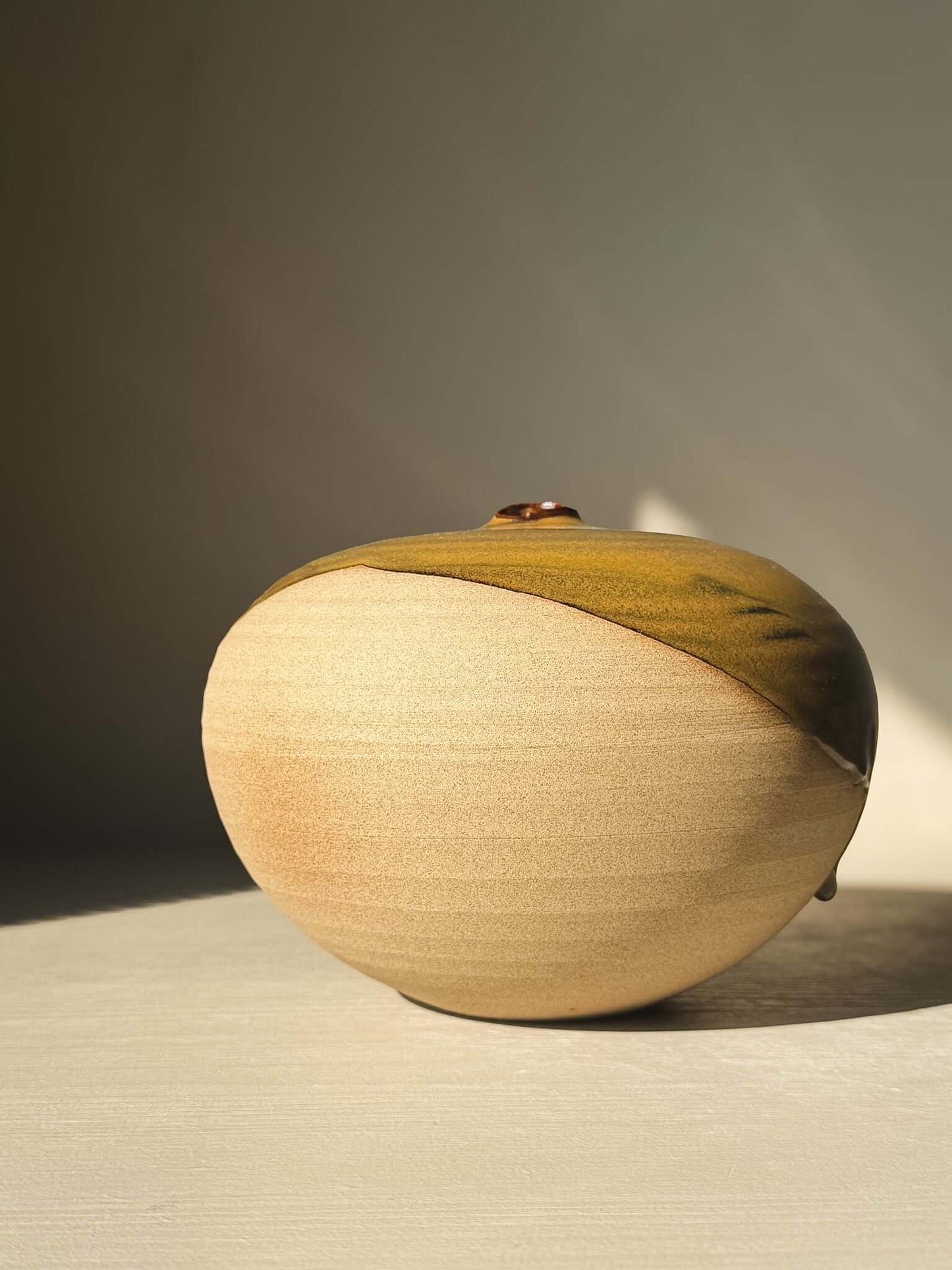 Orb Vase – #18 featuring a unique spherical design, soft glaze drips, and organic patterns on a rounded, sculptural form.