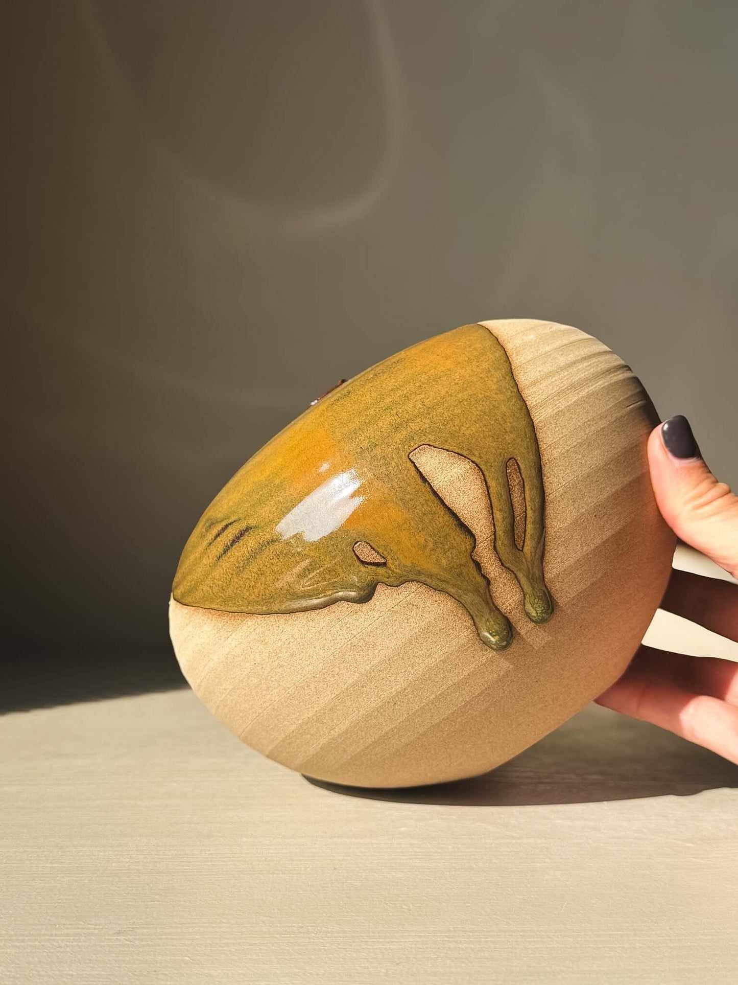 Close-up of Orb Vase – #18 showcasing unique glaze patterns and rounded clay form, highlighting sculptural elegance and organic design.