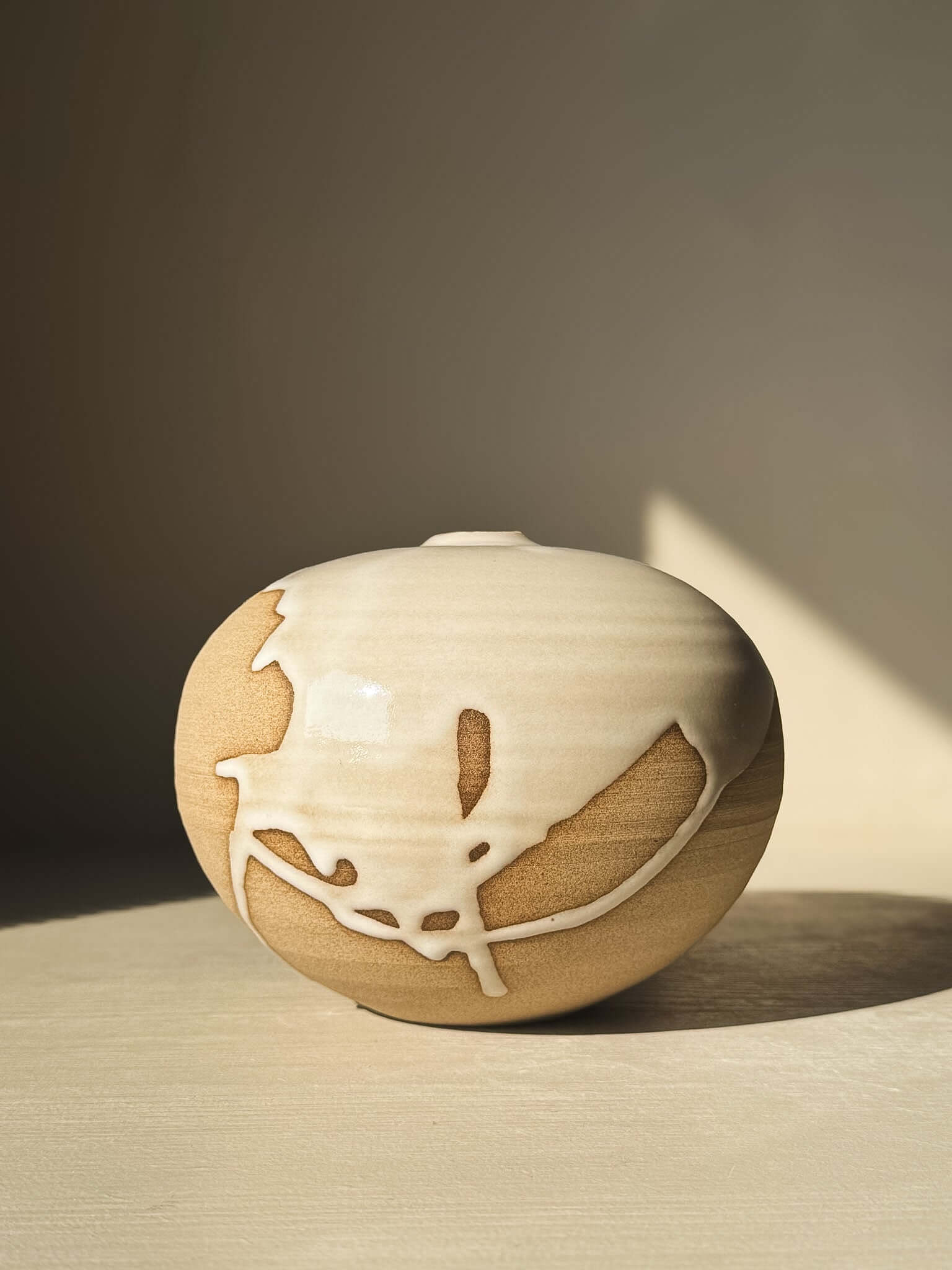 Orb Vase – #16 featuring a rounded, soft spherical form with natural glaze drips creating unique organic patterns on the surface.