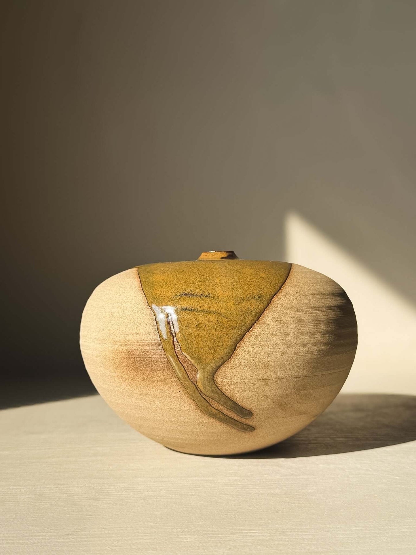 Orb Vase – #15 with unique glaze pattern, soft spherical form, and organic design reflections in natural light.
