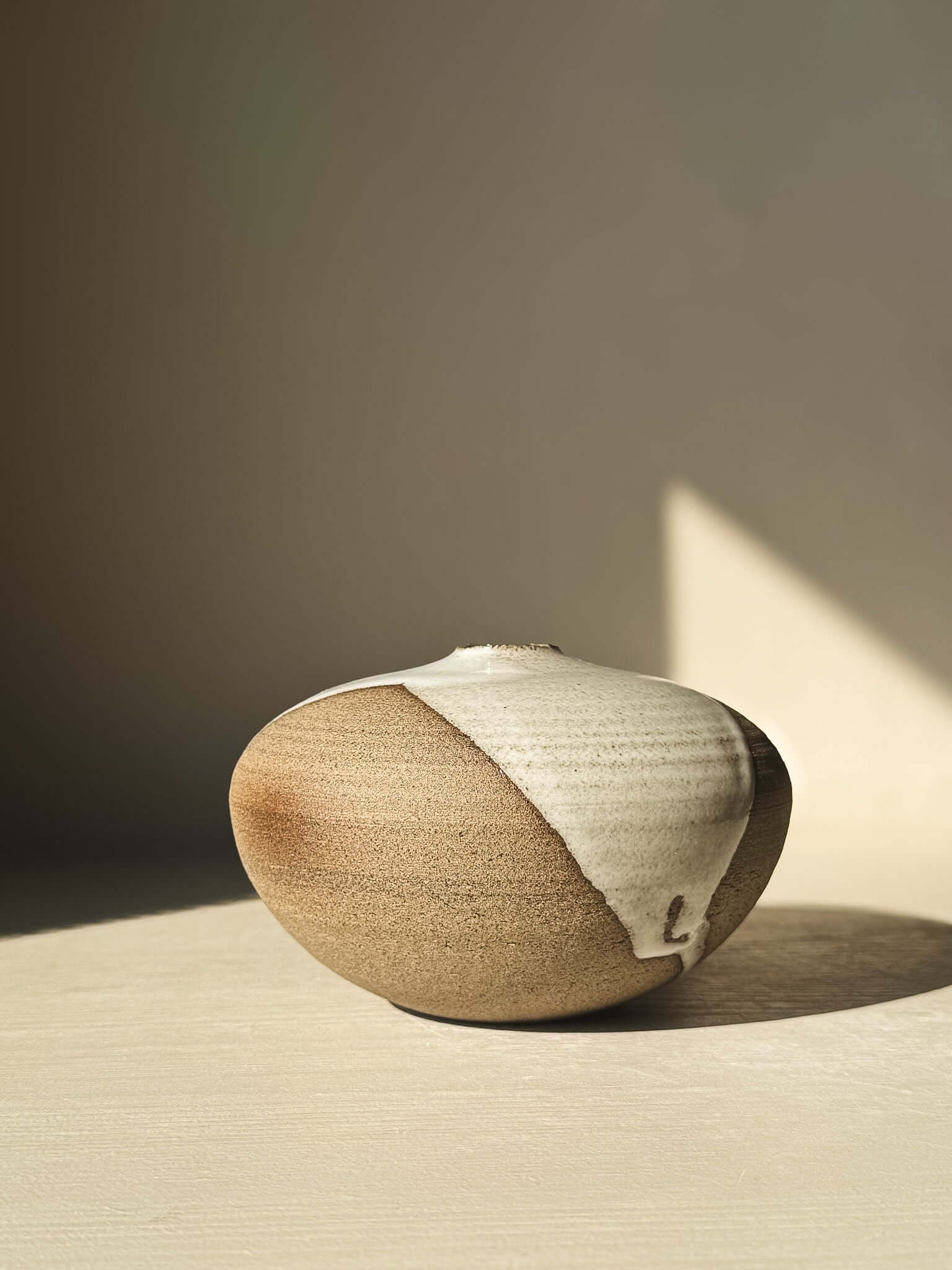 Elegant Orb Vase – #13 with natural glaze drips, showcasing unique clay patterns and sculptural spherical design.