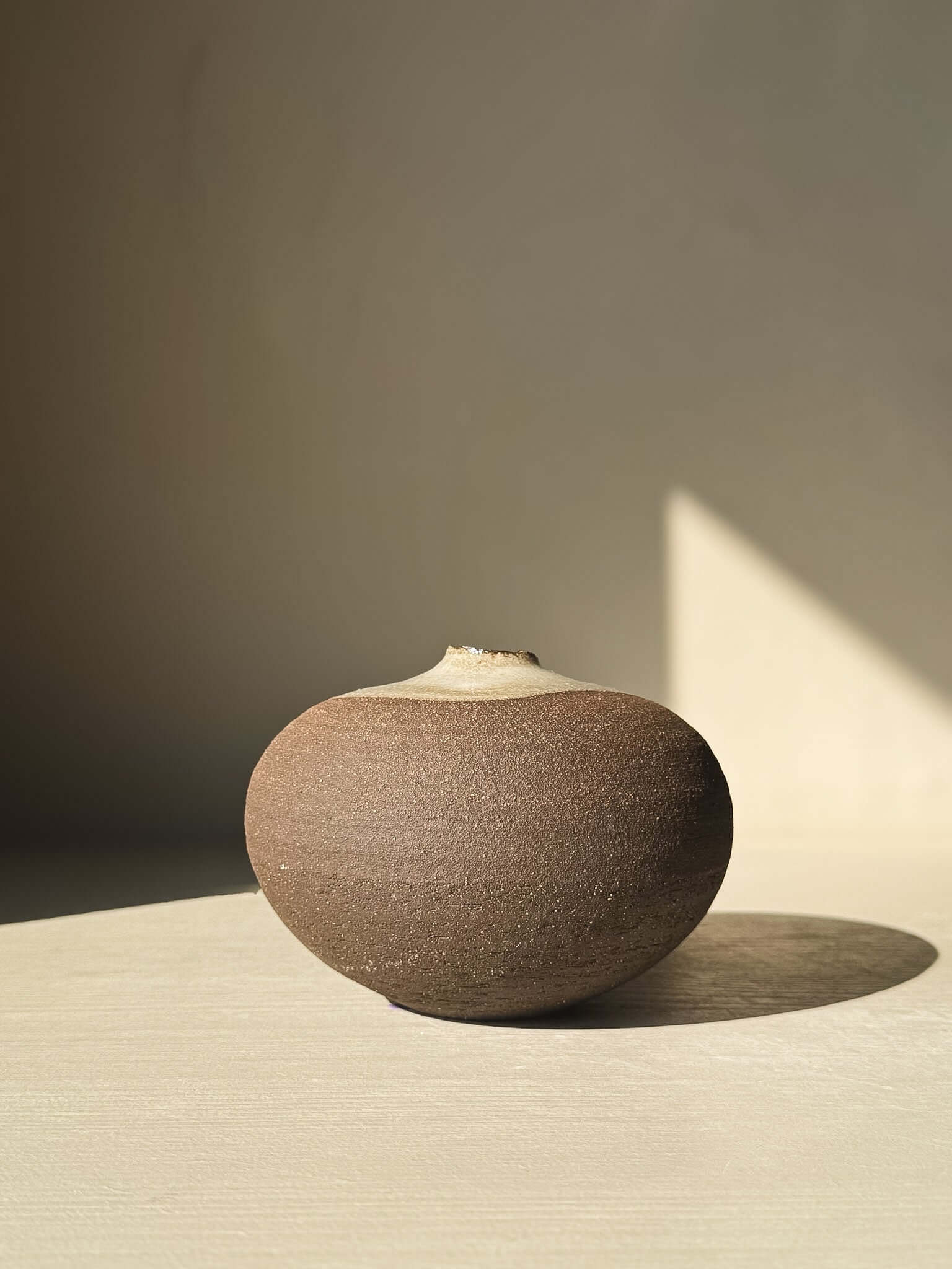 Orb Vase – #12 with a rounded shape and natural glaze pattern on a neutral background, part of a unique sculptural vase collection.