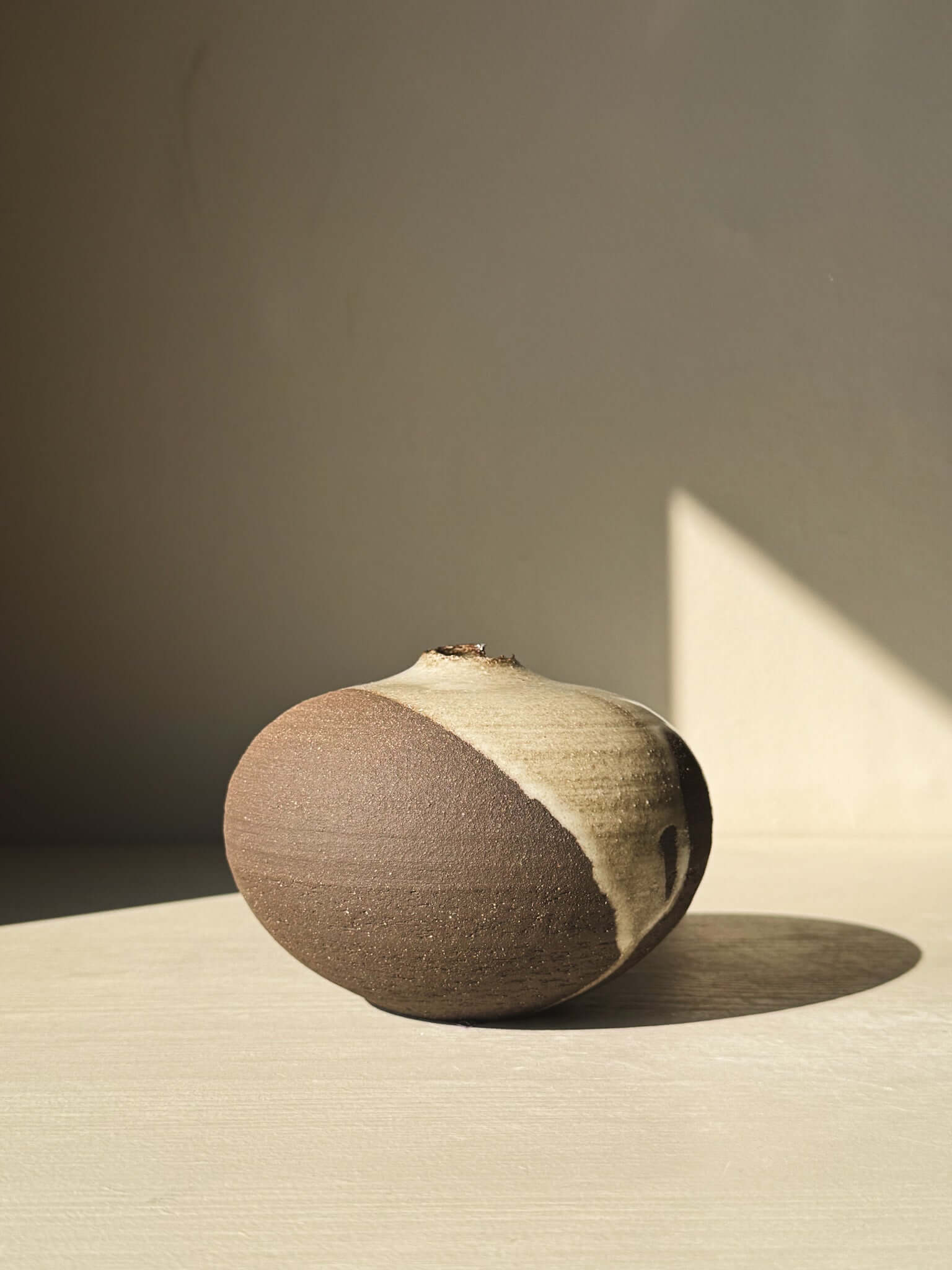 Handcrafted Orb Vase – #12 with unique glaze patterns on a rounded clay form