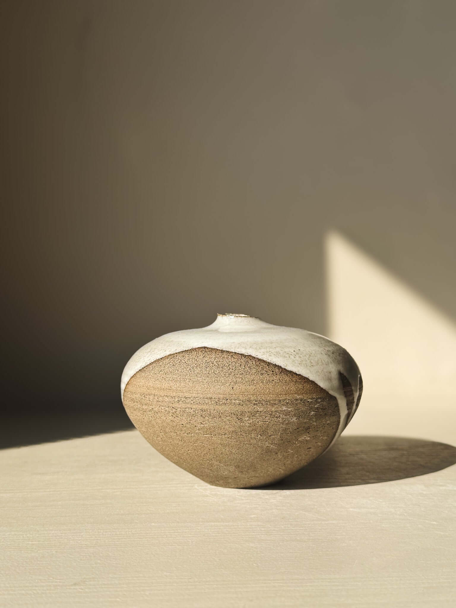 Orb Vase – #10 with unique glaze patterns and rounded design, enhancing its sculptural aesthetic in natural lighting.