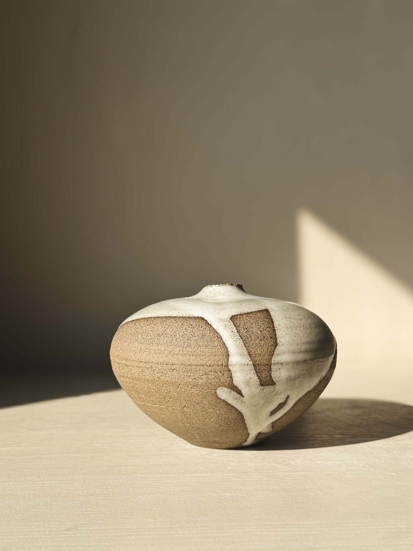 Clay Orb Vase – #10 with unique glaze patterns, showcasing calm sculptural form and organic drips on surface.