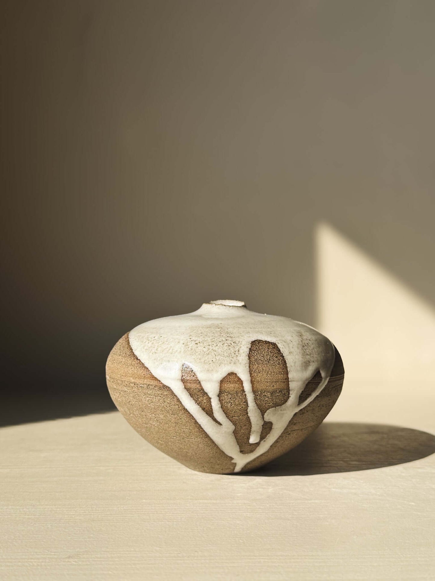 Orb Vase – #10 with organic glaze patterns and rounded shape, showcasing unique craftsmanship in a soft, sculptural design.