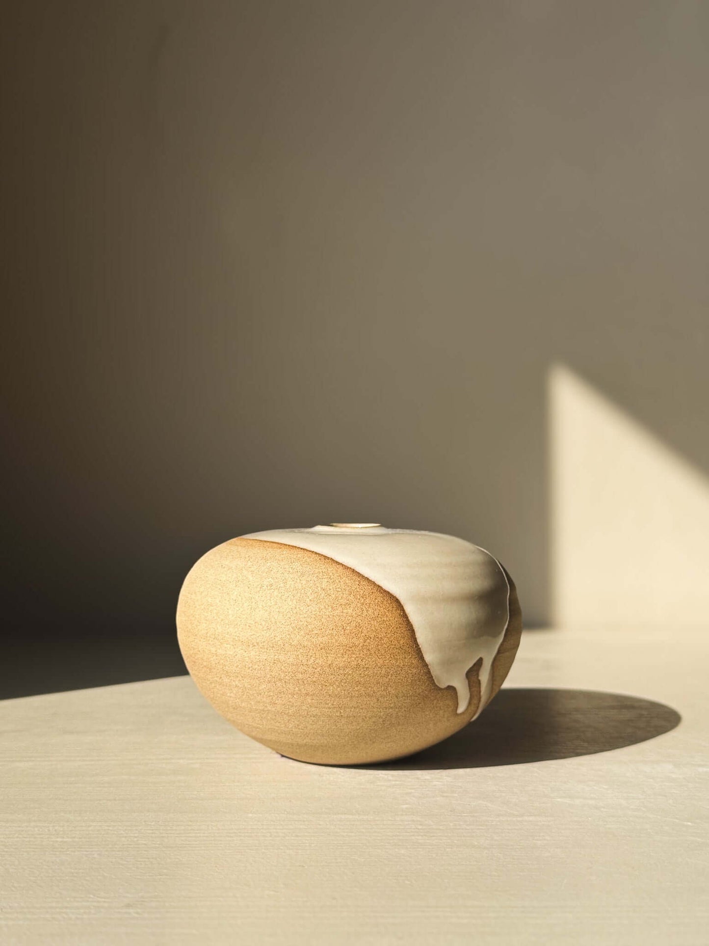 Orb Vase – #06 with natural glaze drips and organic patterns, showcasing a calm spherical design and sculptural presence.