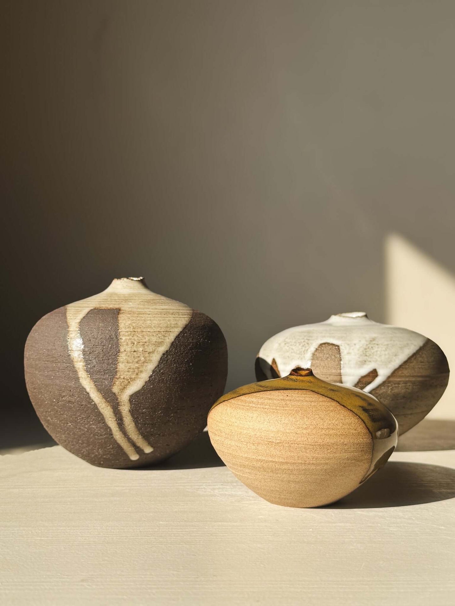 Three Orb Vase – #13 pieces featuring natural glaze drips, showcasing unique clay textures and sculptural presence.