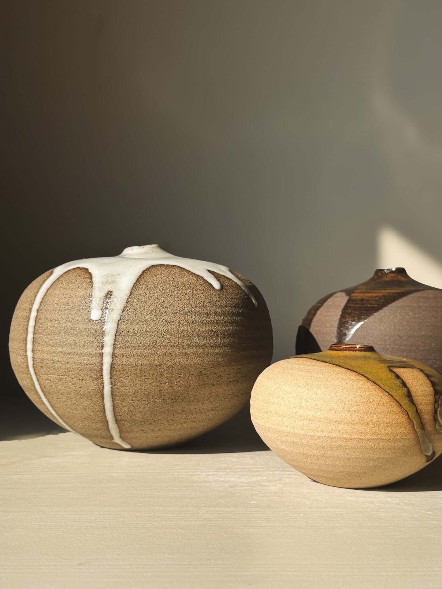 Handcrafted Orb Vase – #17 with unique glaze patterns from the rounded vessel collection, showcasing a calm, sculptural presence.