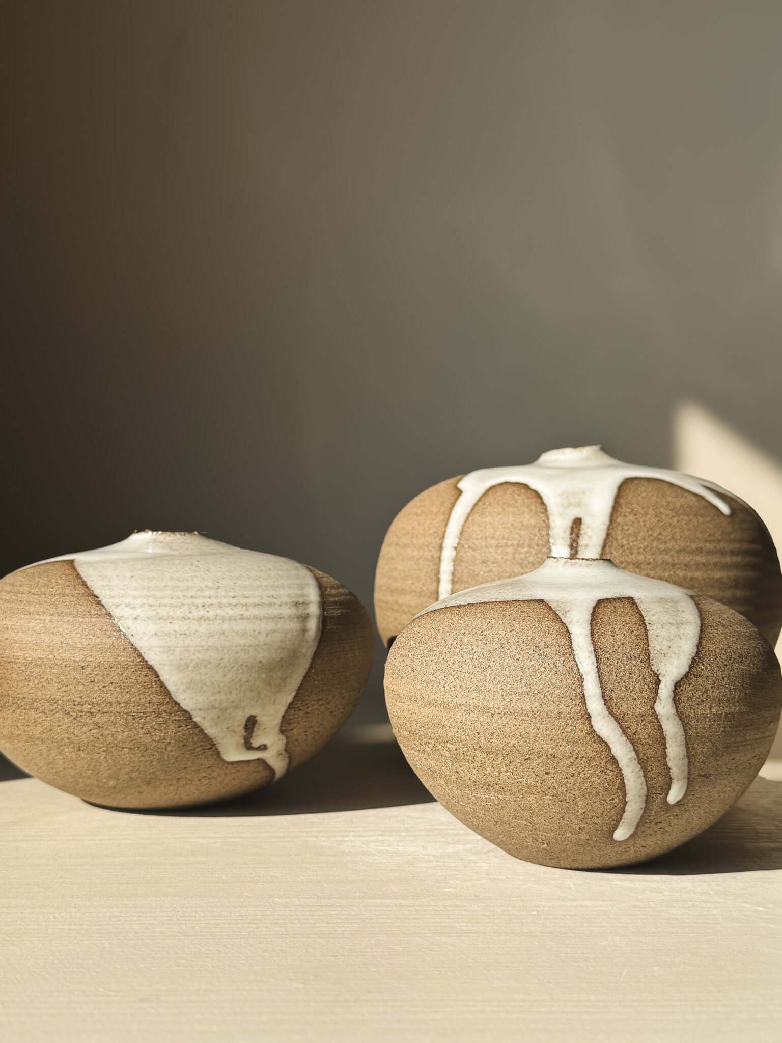 Set of three Orb Vase – #08 with natural glaze drips, showcasing unique organic patterns and sculptural presence.