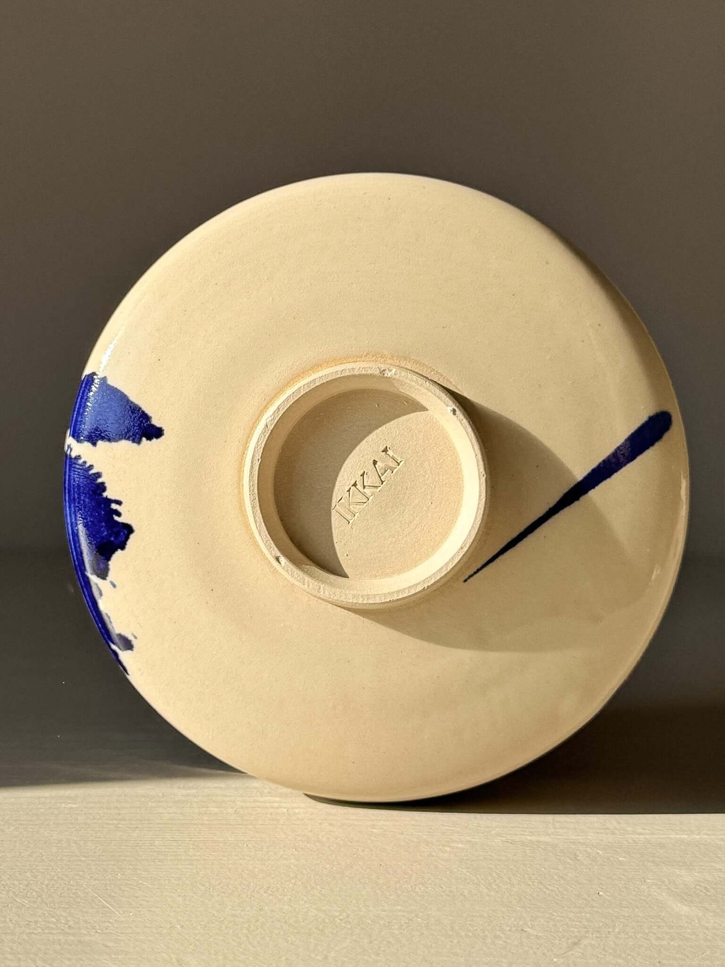 Underside view of Matcha Bowl – Gosu Series #04 with cobalt glaze accents.