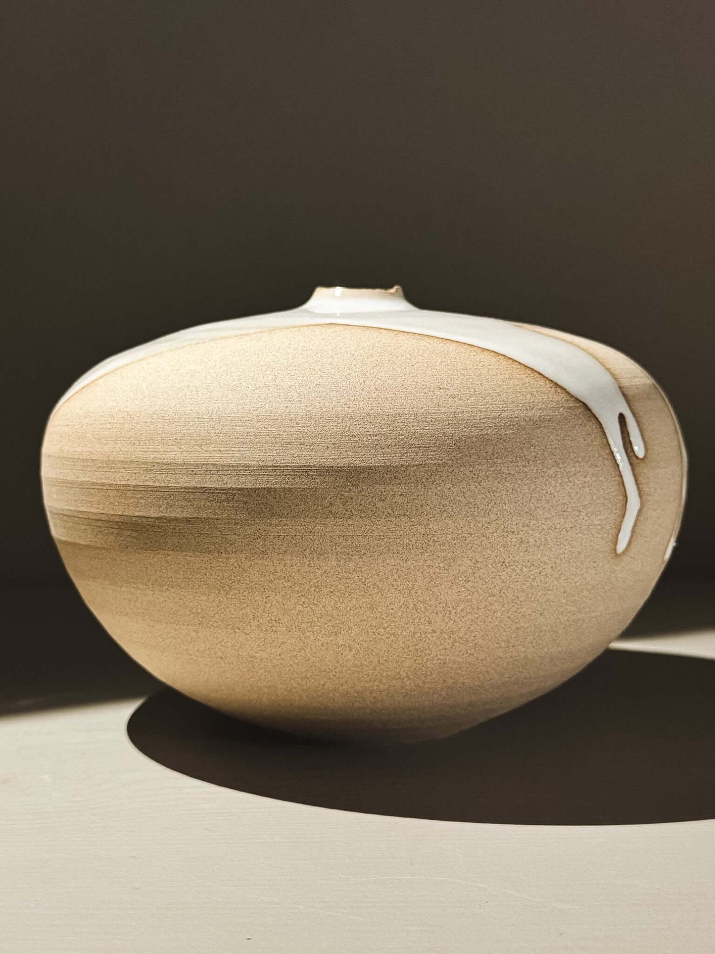 Orb Vase – Yuki #01 with soft spherical form and organic glaze patterns on a neutral background.