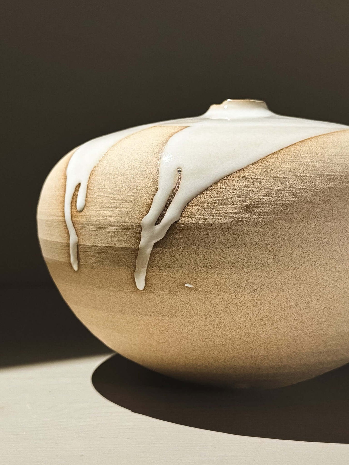 Orb Vase – Yuki #01 showcasing unique glaze drips and a rounded sculptural form.