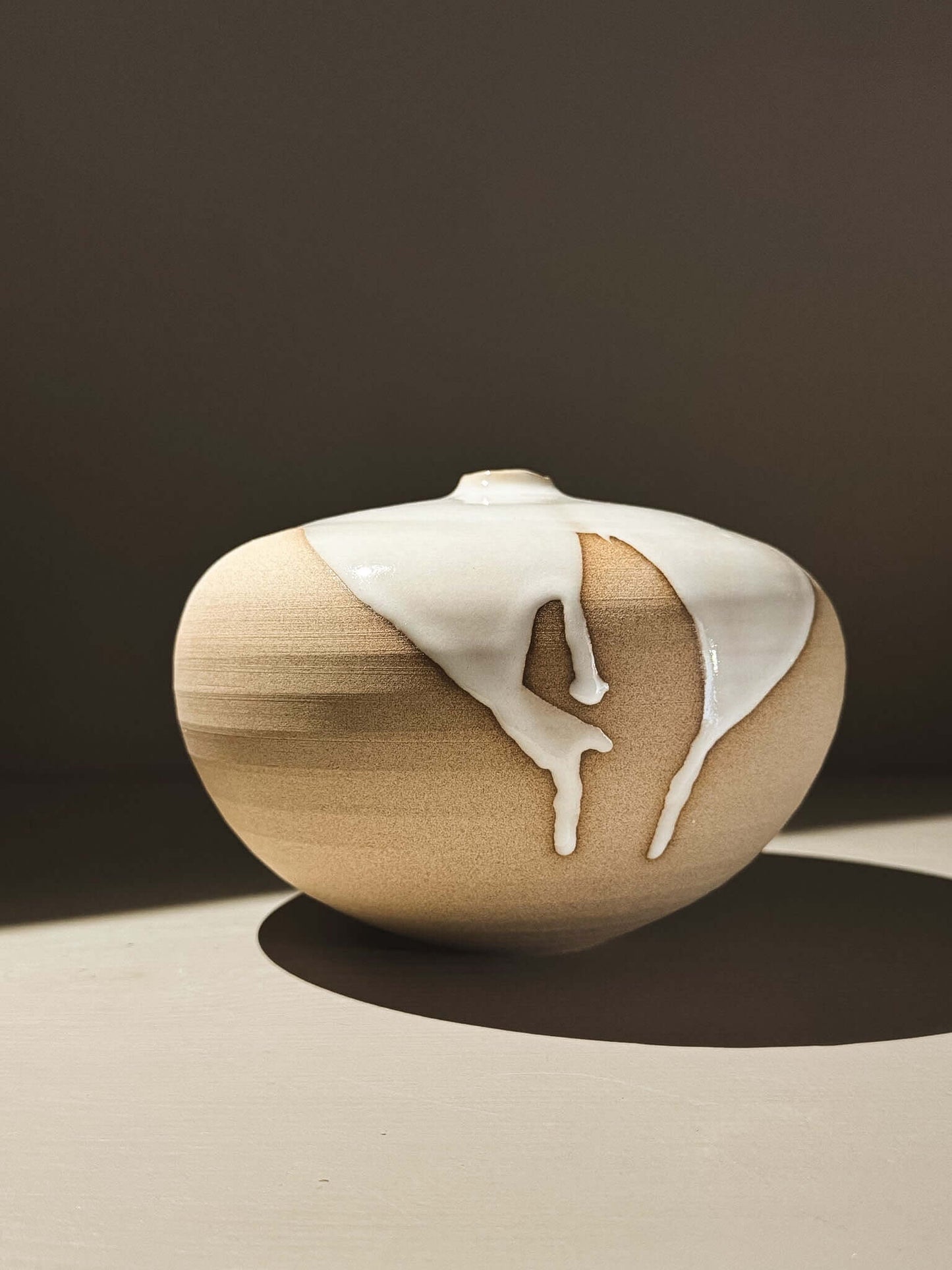 Orb Vase – Yuki #01 with unique glaze patterns and soft spherical form, showcasing its artistic design and individuality.