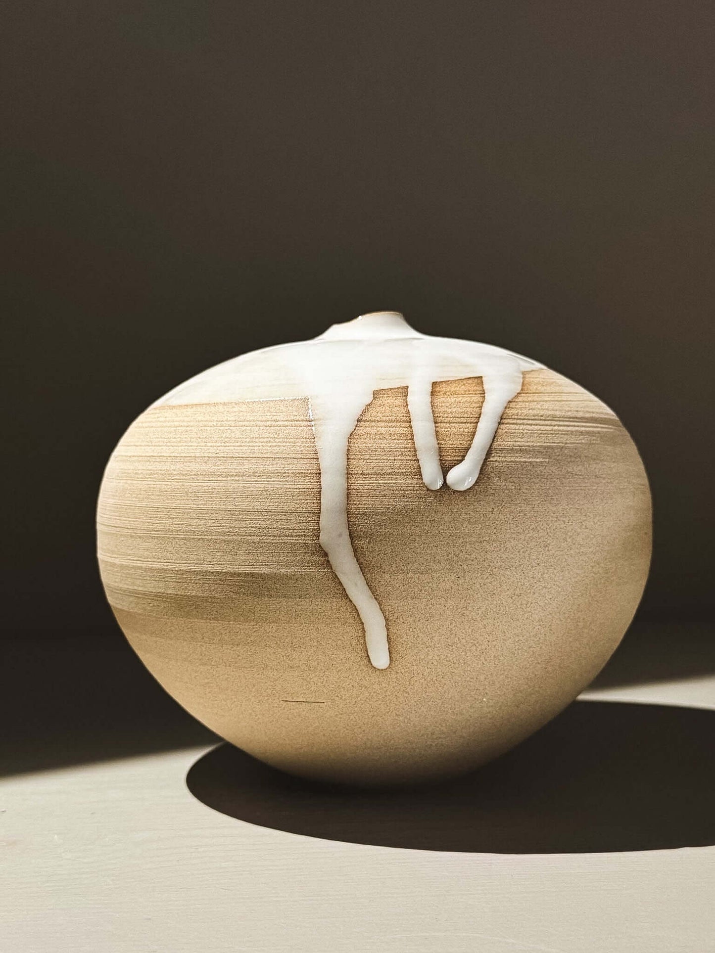 Orb Vase – Yuki #02 showcasing unique glaze movement and soft spherical form in natural light.