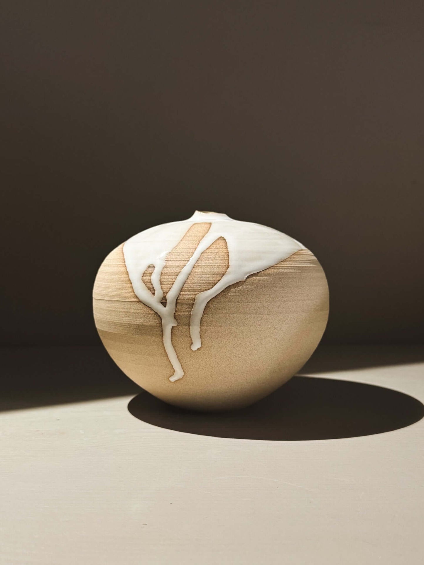 Orb Vase – Yuki #02 showcasing unique glaze patterns and soft, rounded form on a minimalist background.