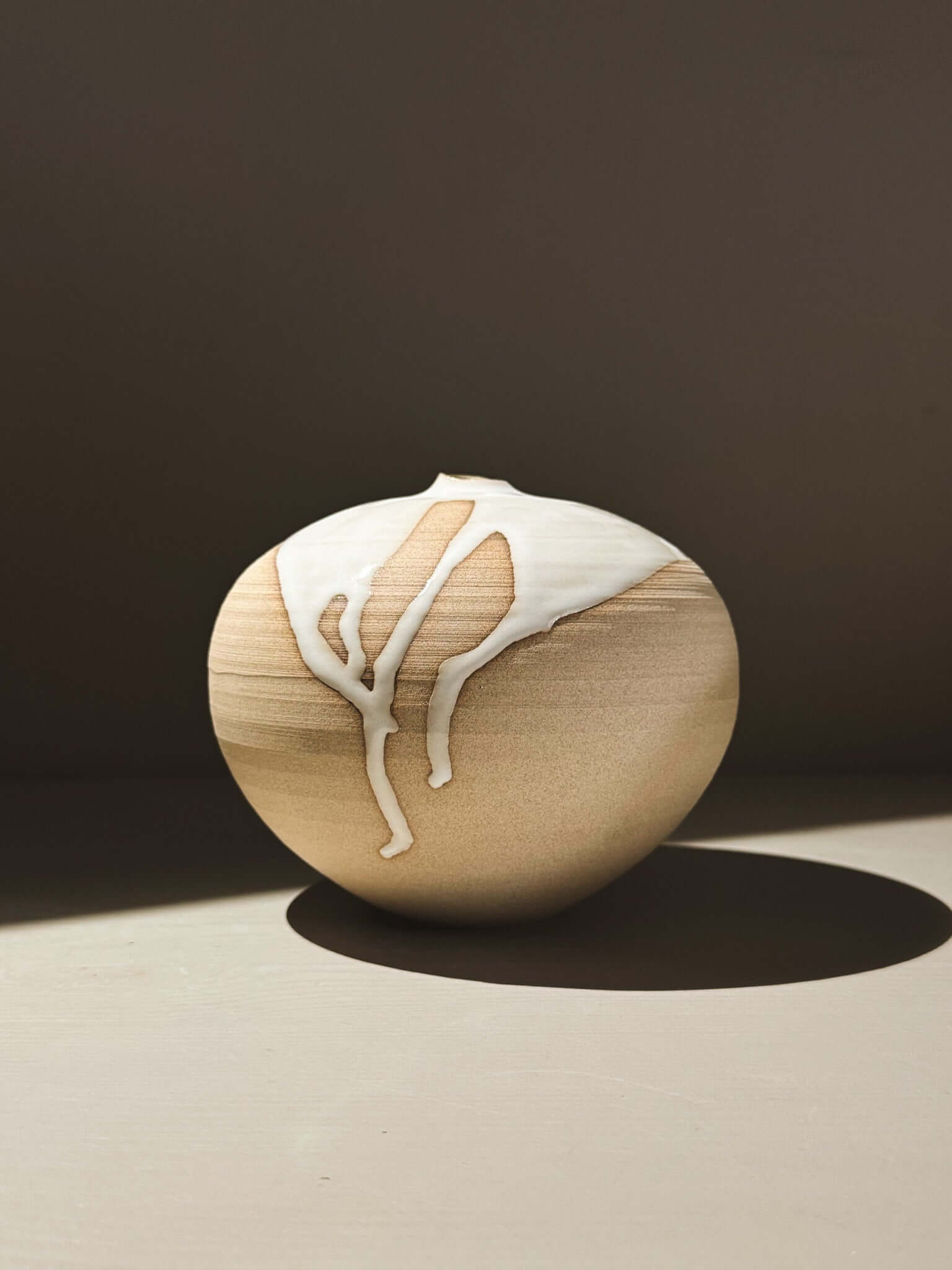 Orb Vase – Yuki #02 showcasing unique glaze patterns and soft, rounded form on a minimalist background.