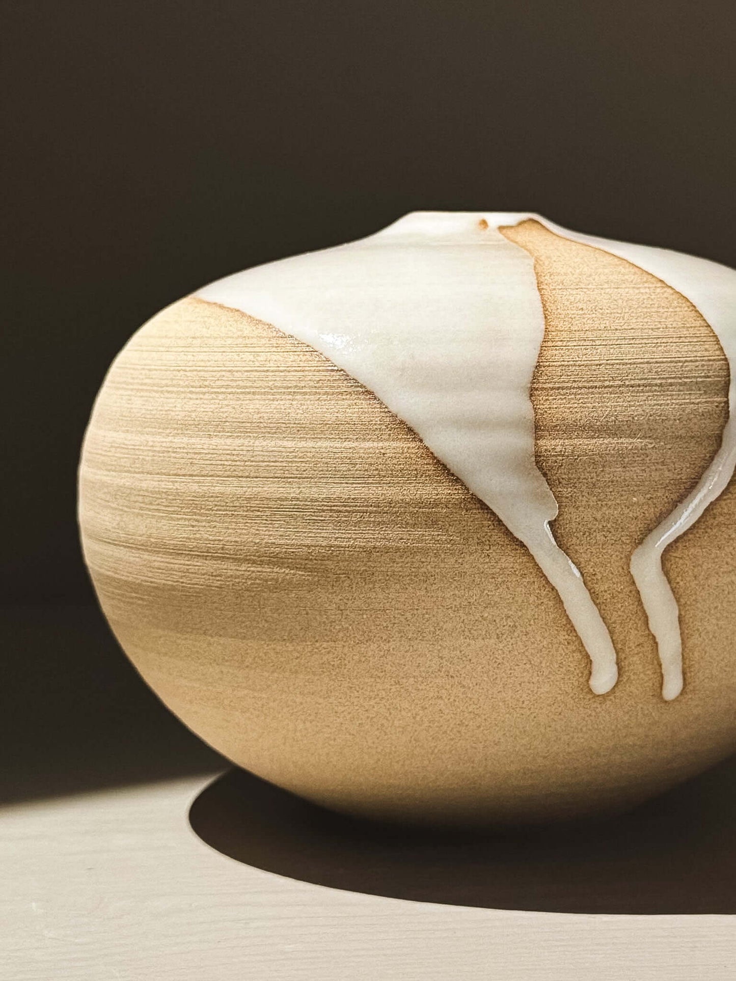 Orb Vase – Yuki #03 with unique glaze patterns and soft spherical form, showcasing organic design.