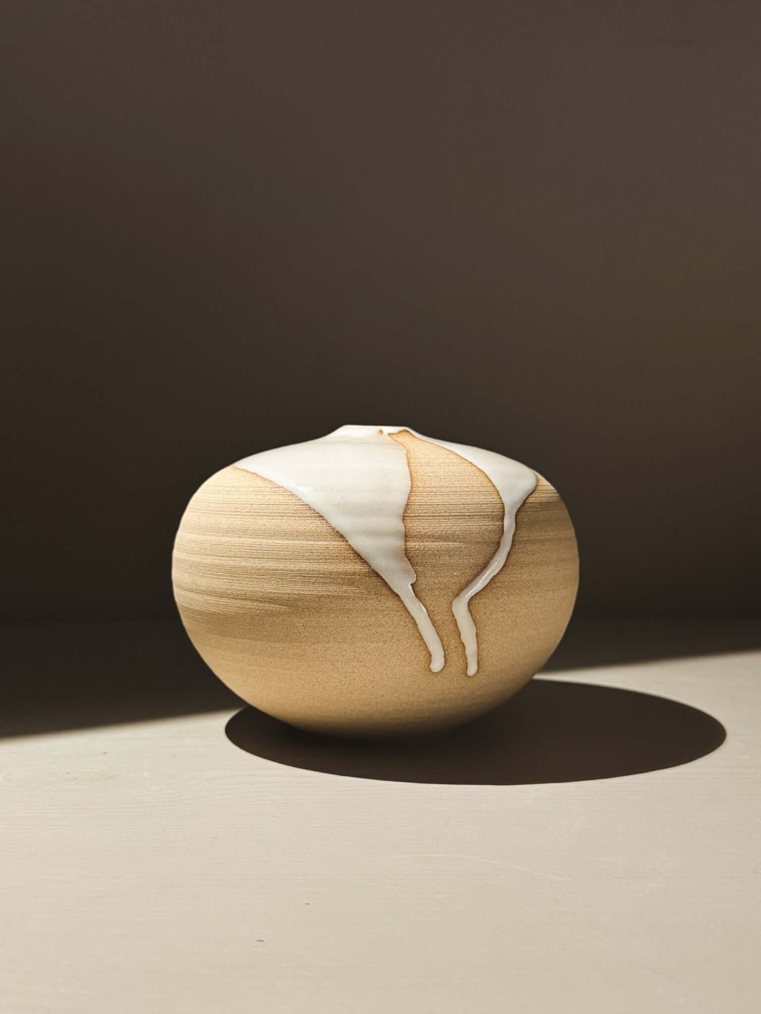 Orb Vase – Yuki #03 featuring a unique glaze with organic patterns and a soft spherical shape.