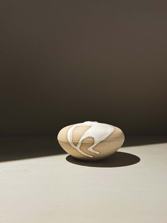 Orb Vase – Yuki #05 displayed with unique glaze movement and organic patterns on a soft rounded form.