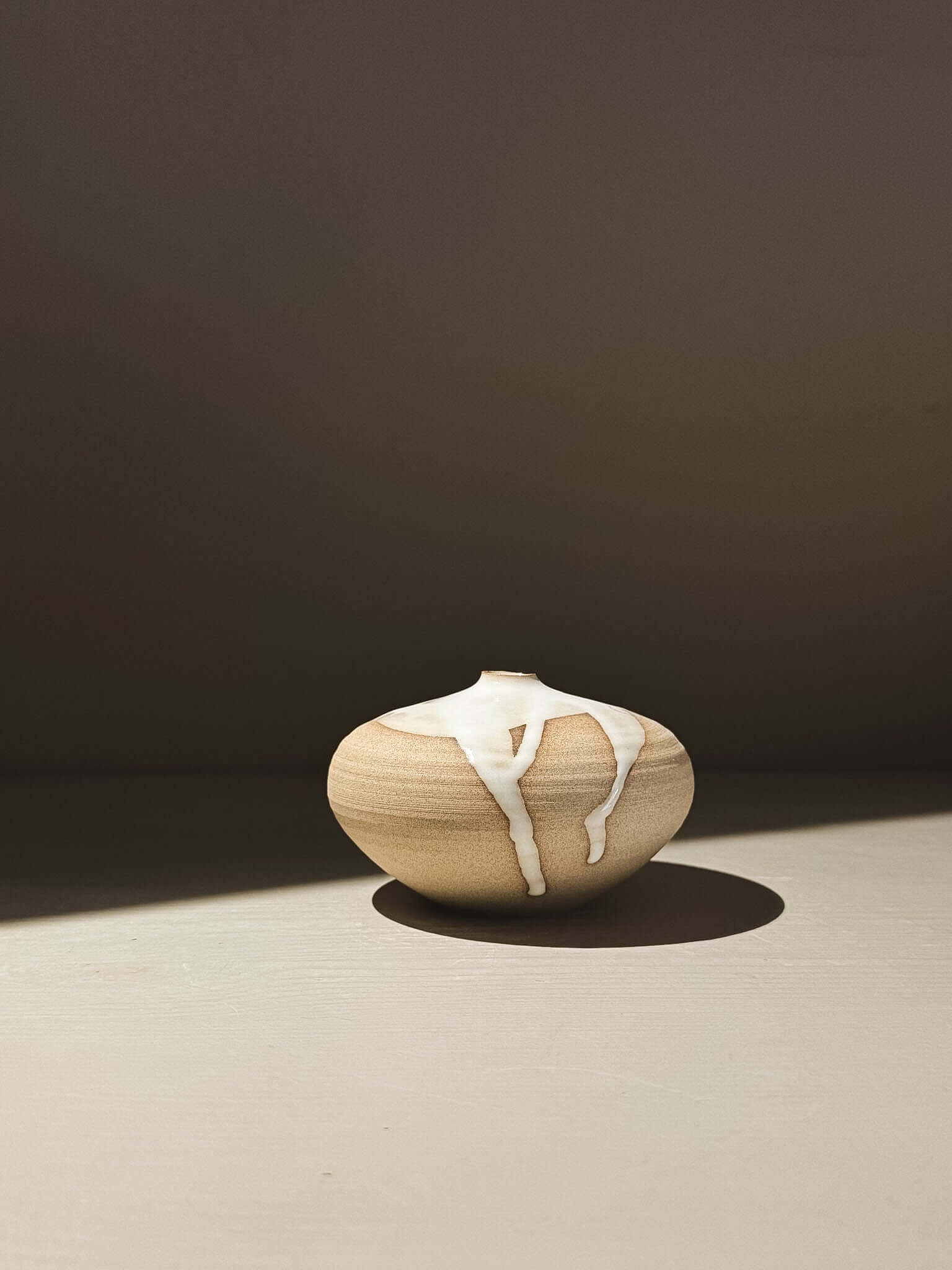 Orb Vase – Yuki #06 with unique glaze drips and soft spherical form, enhancing any decor.
