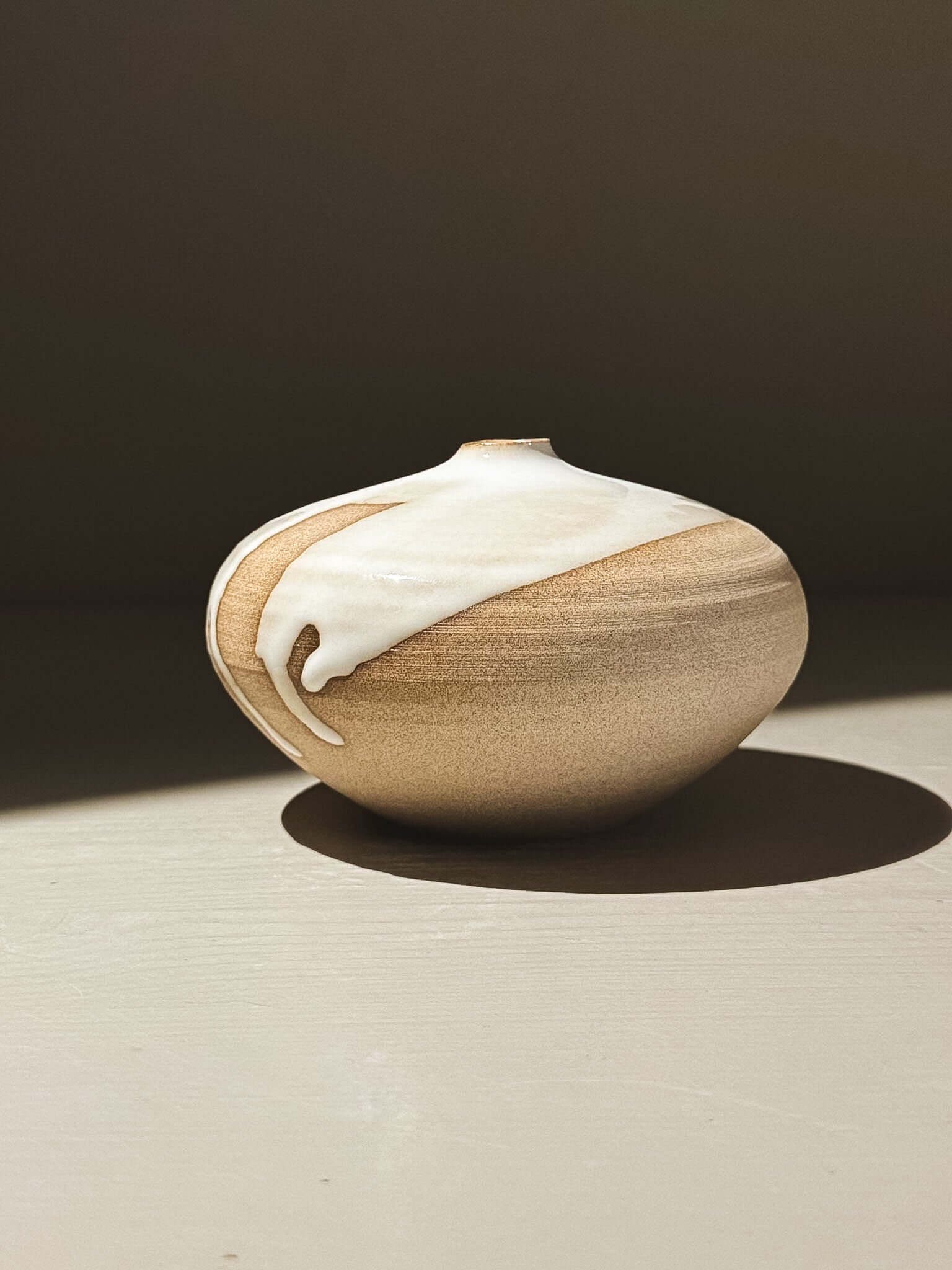 Orb Vase – Yuki #06 with soft spherical form and unique glaze patterns in natural light.
