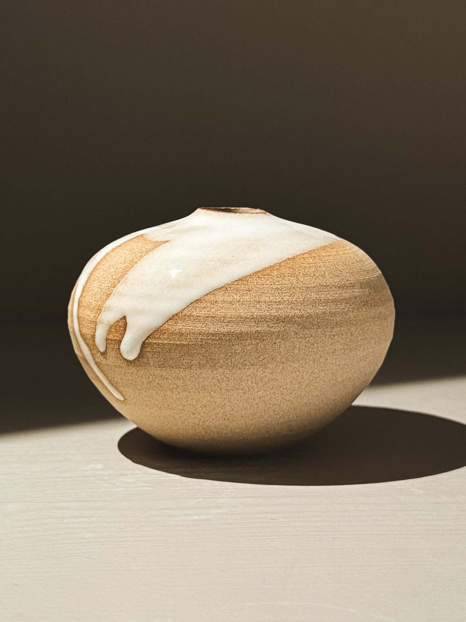Orb Vase – Yuki #07 with unique glaze patterns and soft spherical form, showcasing organic beauty.
