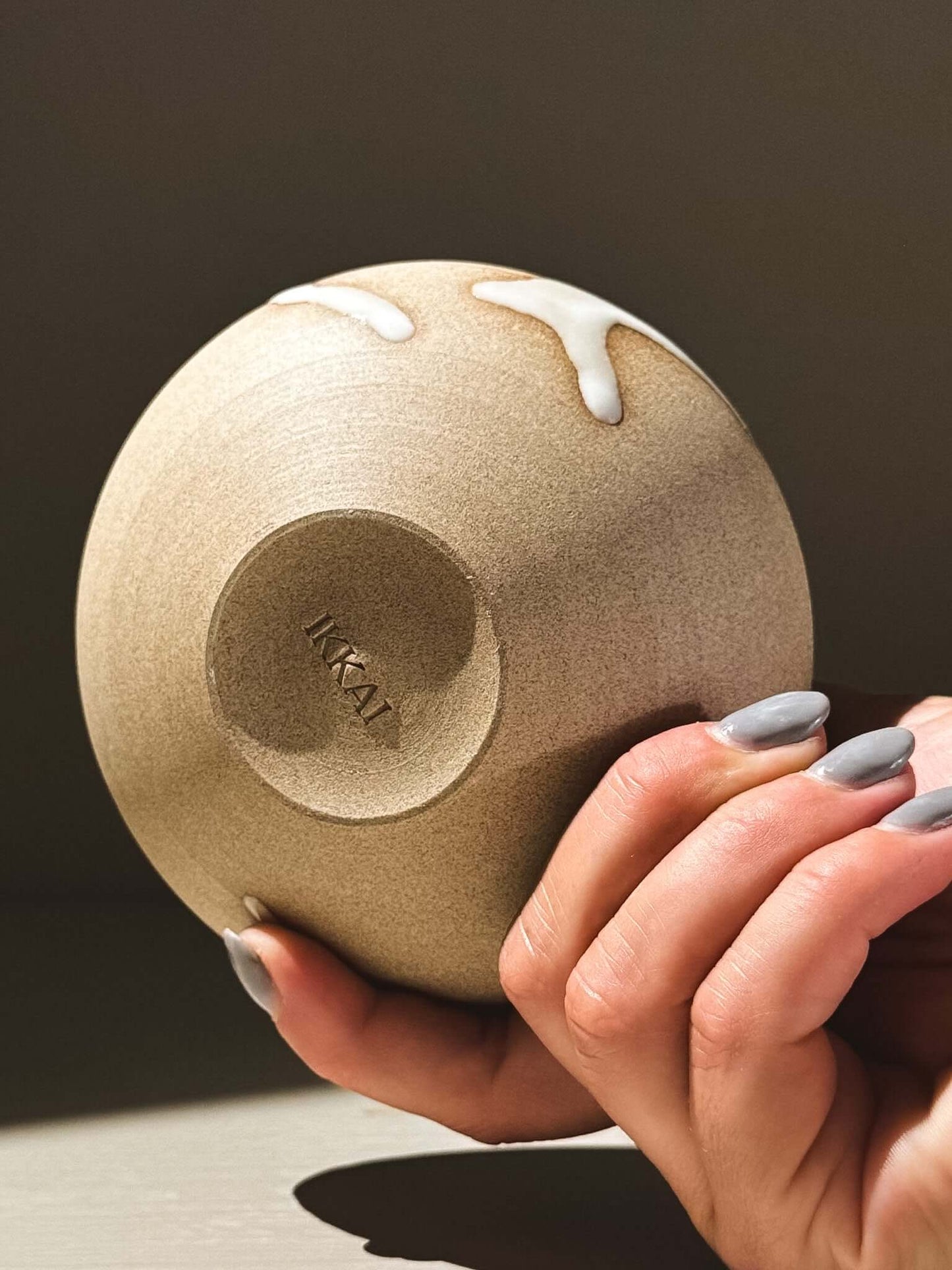 Orb Vase – Yuki #08 held in hand showcasing unique glaze and sculpture-like design.