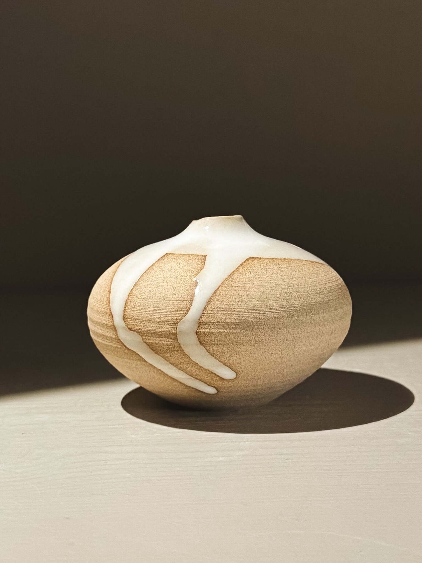 Orb Vase – Yuki #09 with natural glaze patterns on a soft spherical form.