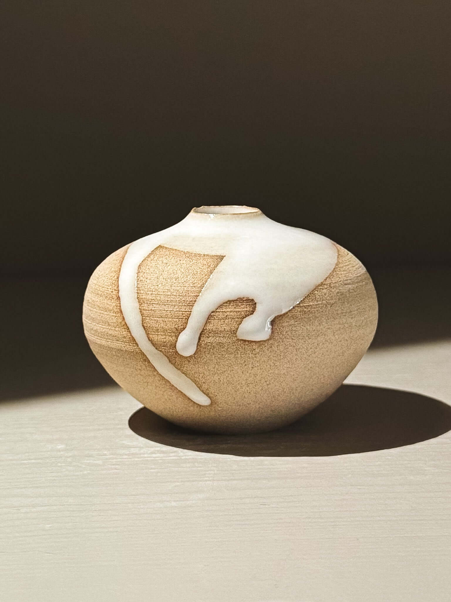 Orb Vase – Yuki #11 showcasing a unique glaze pattern and rounded shape.