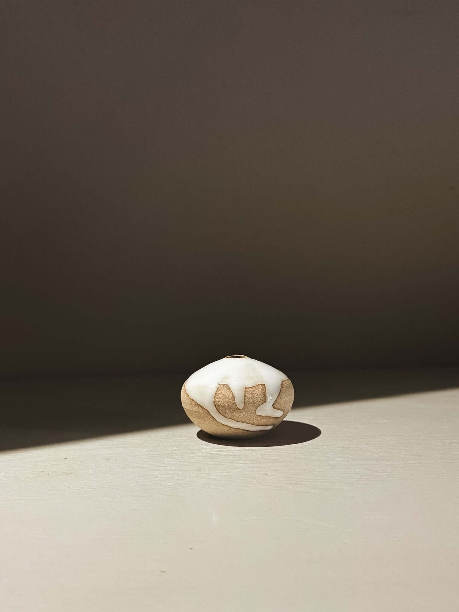 Orb Vase – Yuki #12 featuring unique clay and glaze patterns on a soft rounded form.
