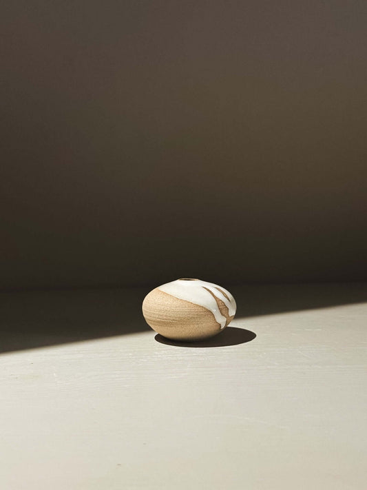 Orb Vase – Yuki #13 on a light surface, featuring a rounded form with natural glaze patterns.