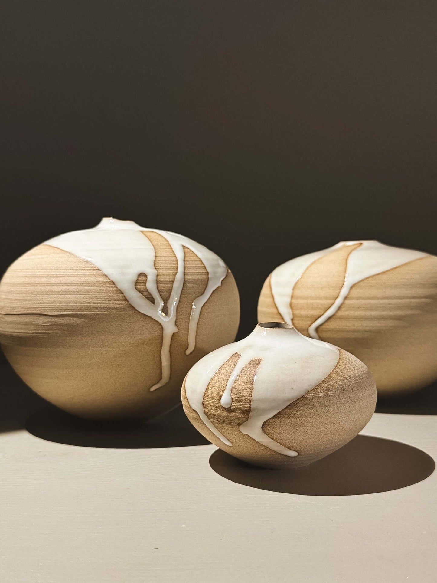 Beautiful Orb Vase – Yuki #02 set showcasing unique glaze patterns and rounded shapes for a sculptural presence.