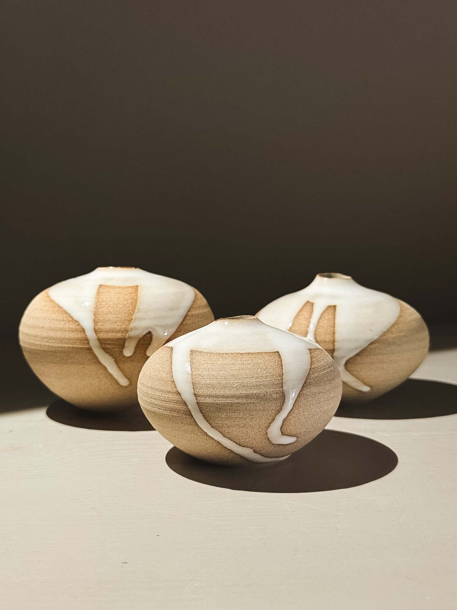 Orb Vase – Yuki #03 trio showcasing unique glaze movement and soft rounded shapes, each with organic patterns.