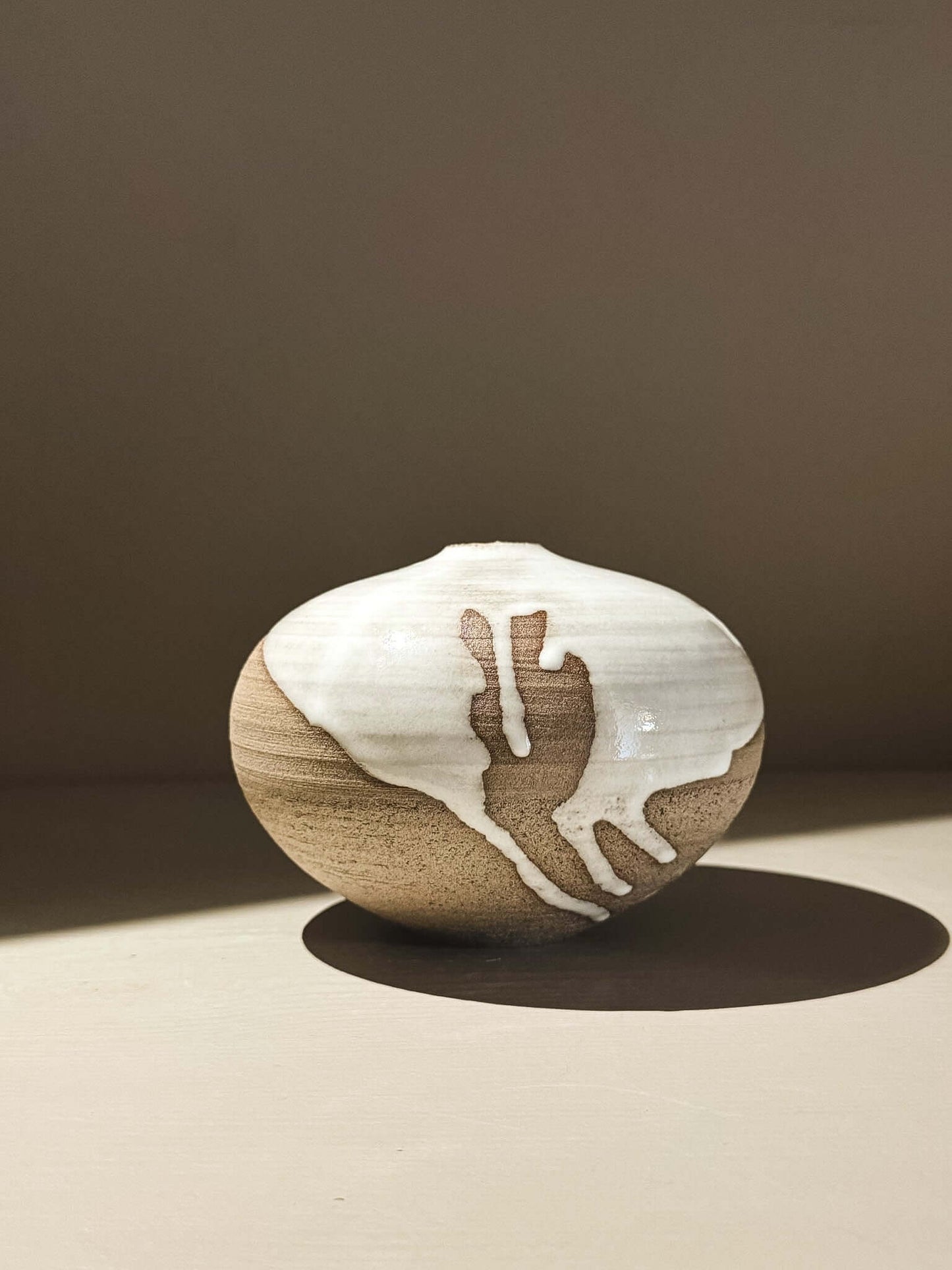 Orb Vase – Yuki Ash #01 showcasing a unique, softly spherical design with organic glaze patterns.