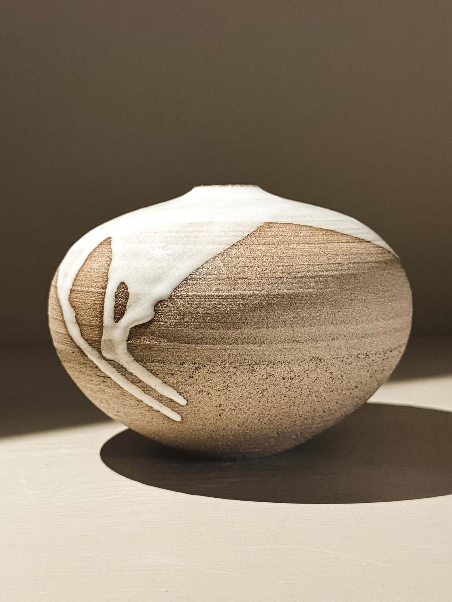 Orb Vase – Yuki Ash #01 showcasing unique glaze patterns and soft spherical form.