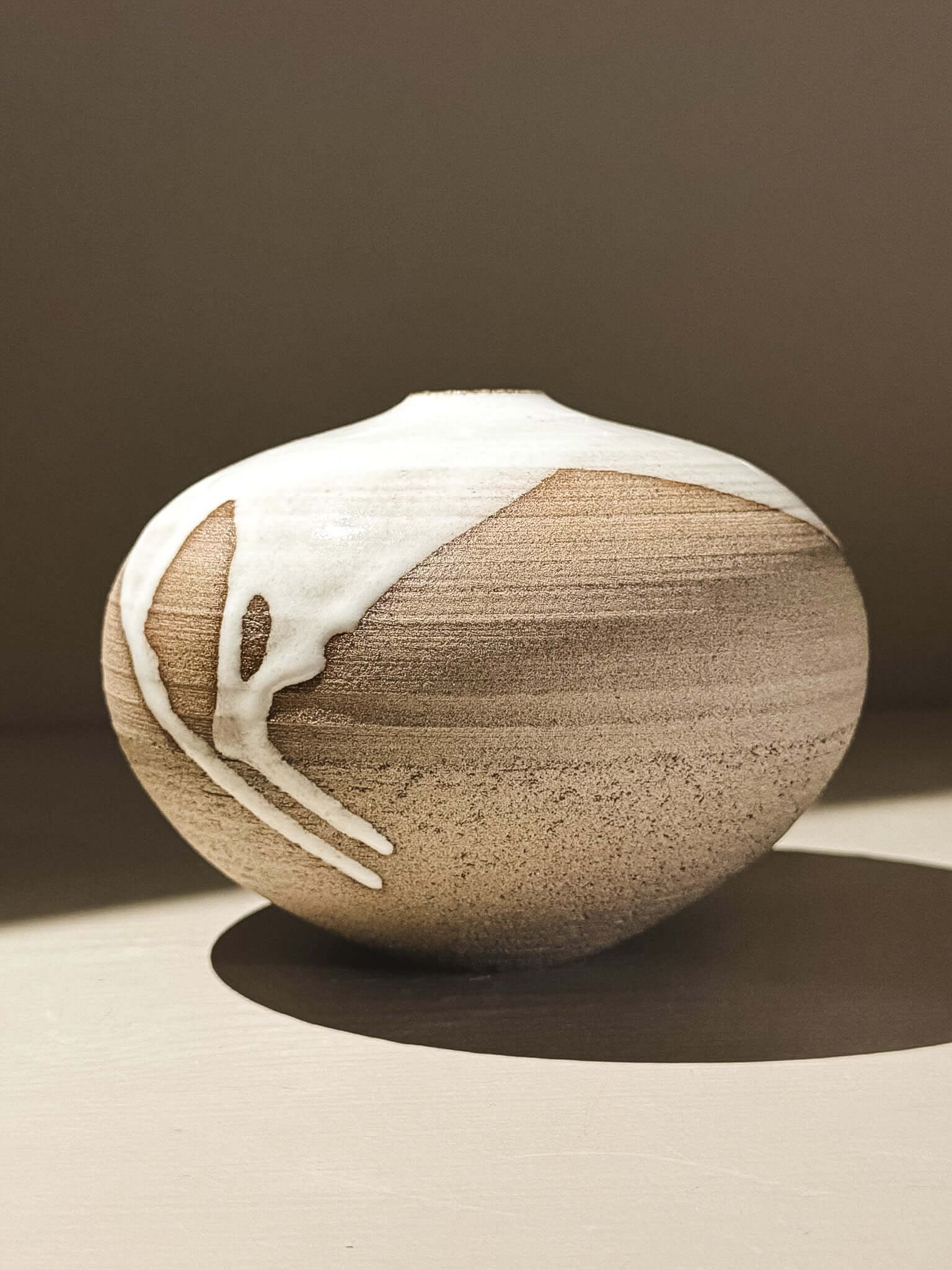 Orb Vase – Yuki Ash #01 showcasing unique glaze patterns and soft spherical form.