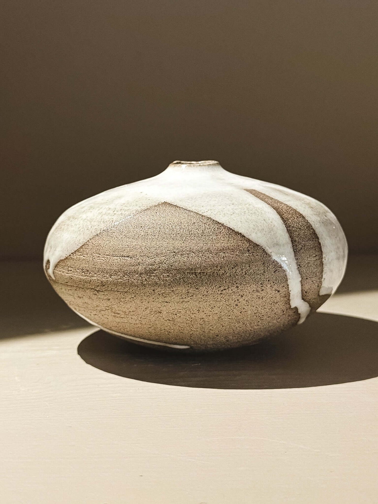 Orb Vase –Yuki Ash #02 featuring a rounded, sculptural design with unique glaze patterns.