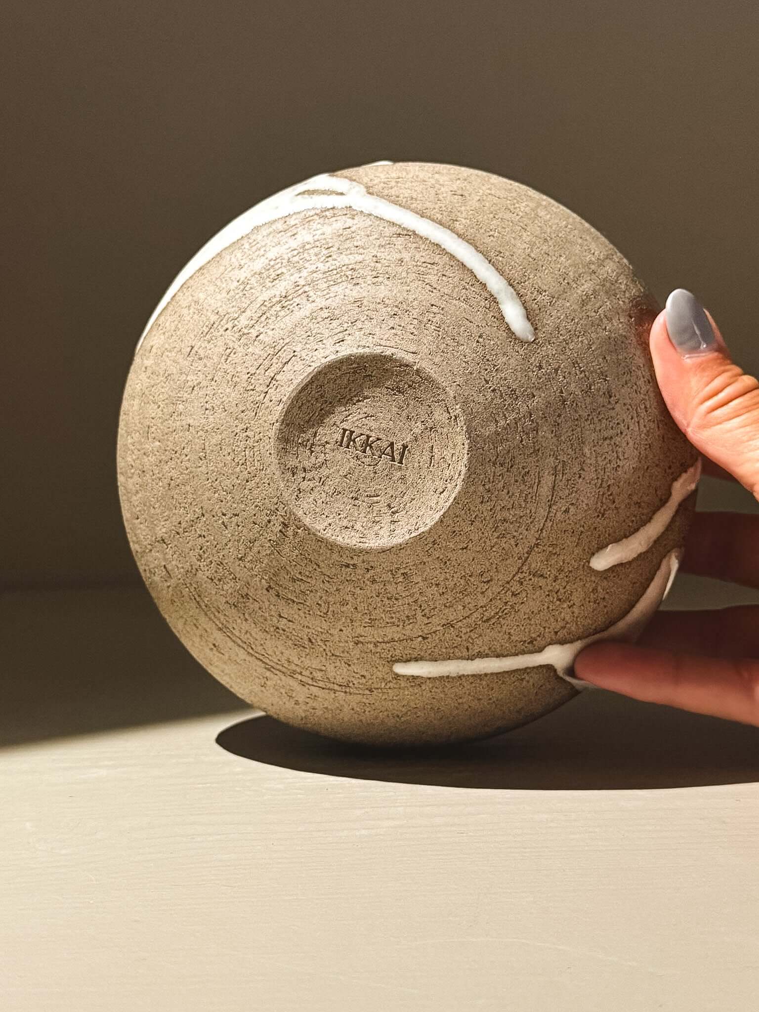 Orb Vase –Yuki Ash #02 with unique glaze patterns and a rounded shape, held in hand.