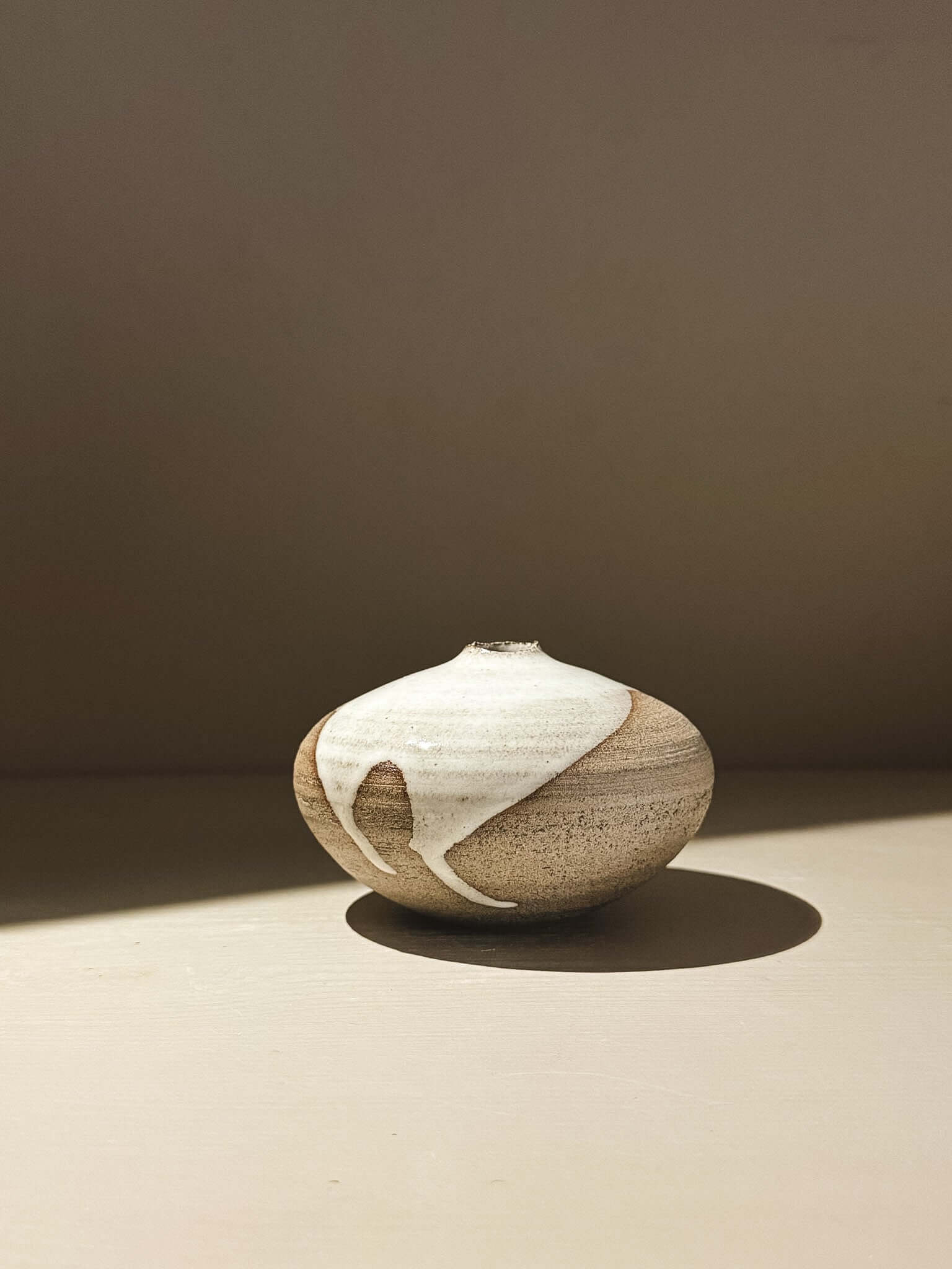 Orb Vase – Yuki Ash #03 in soft spherical form with unique glaze patterns and gentle drips.