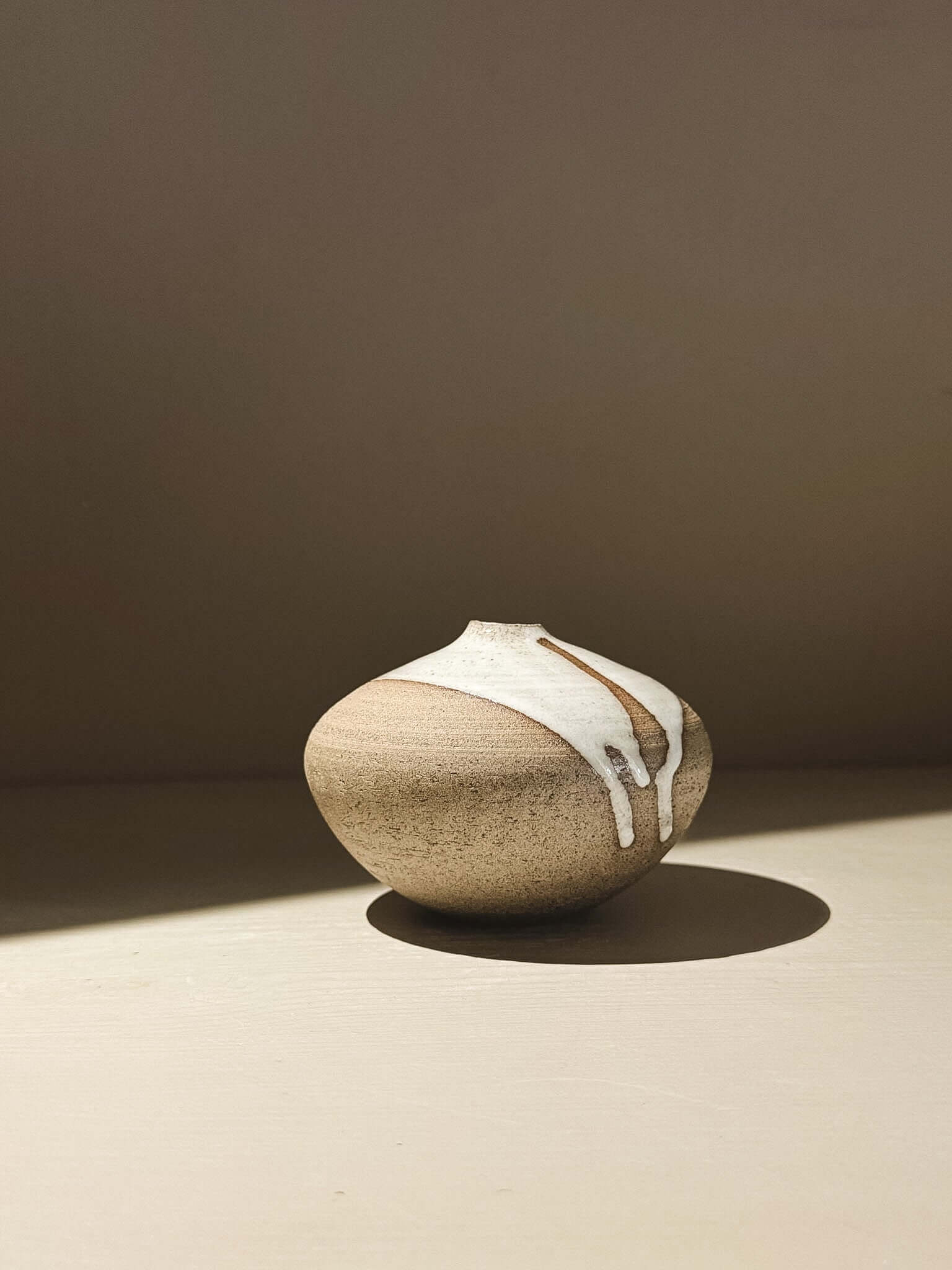 Orb Vase – Yuki Ash #04 showcasing unique glaze patterns and a soft, sculptural form in natural light.