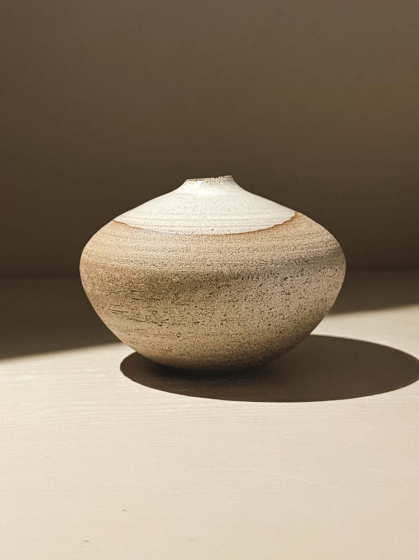 Orb Vase – Yuki Ash #04, a unique rounded ceramic vase with natural glaze patterns and soft spherical form.