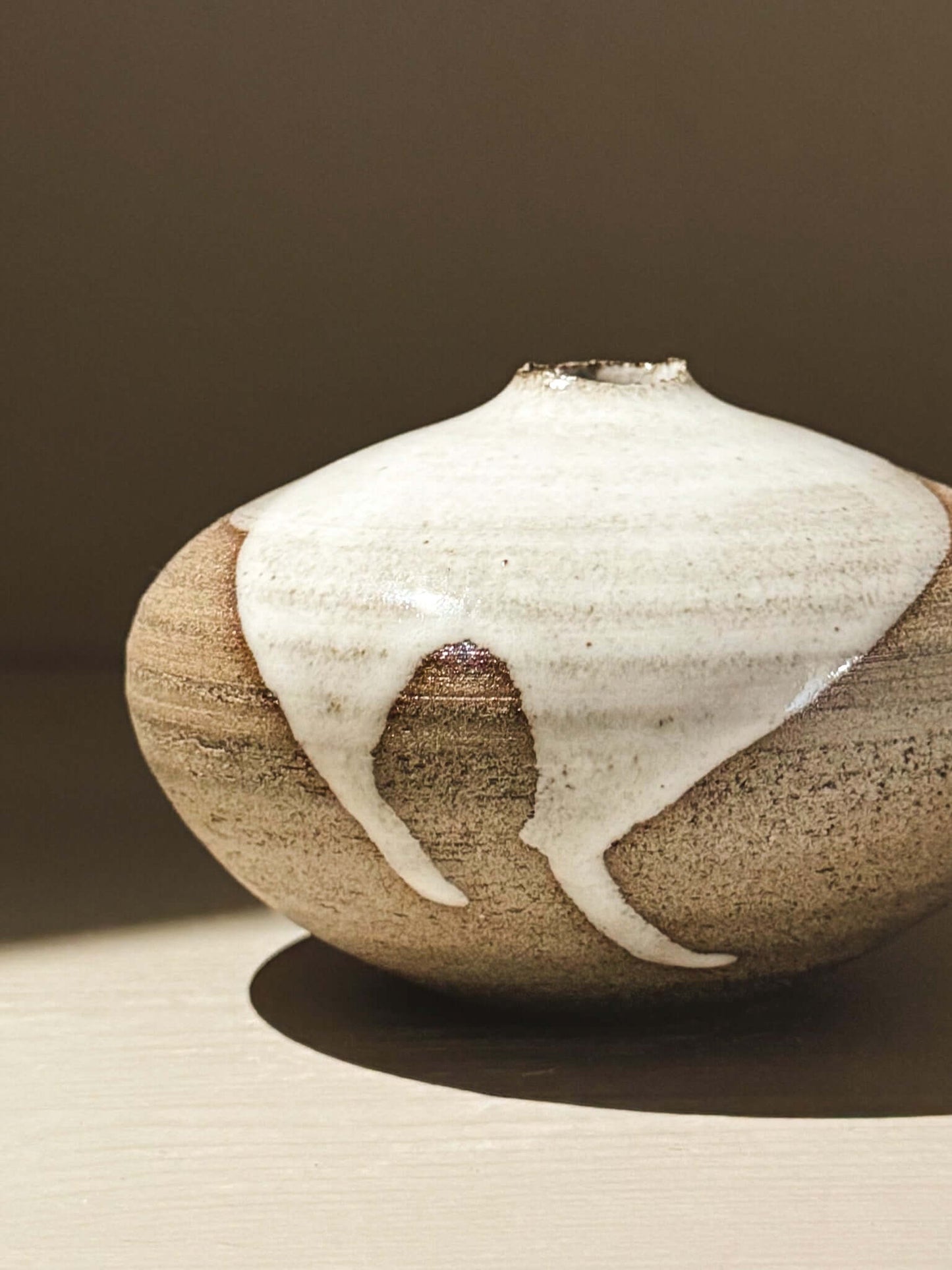 Orb Vase – Yuki Ash #05 showcasing organic glaze patterns and a soft spherical shape on a neutral background.