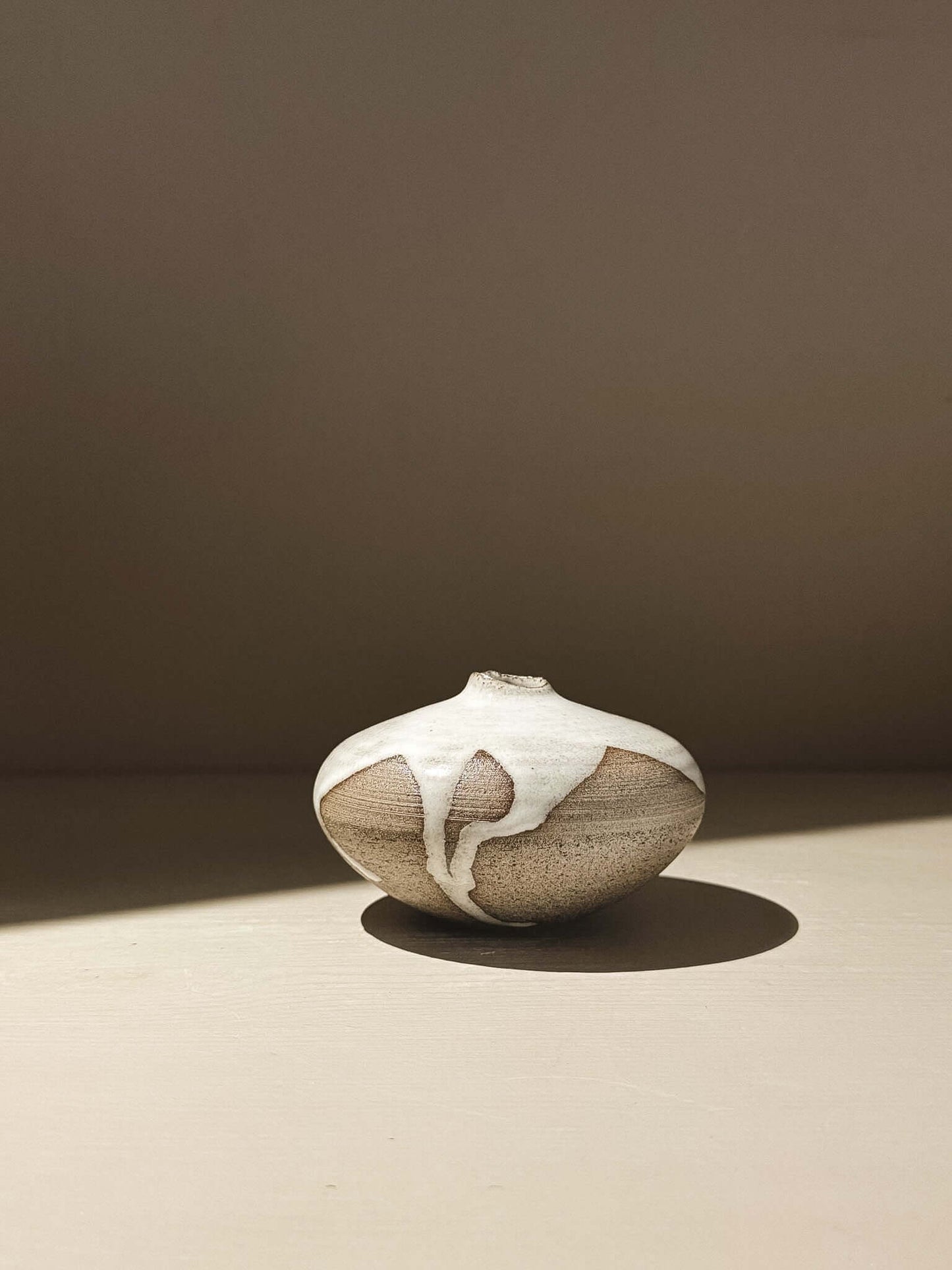 Orb Vase – Yuki Ash #10, a unique japanese handmade ceramic orb vase with organic glaze patterns.