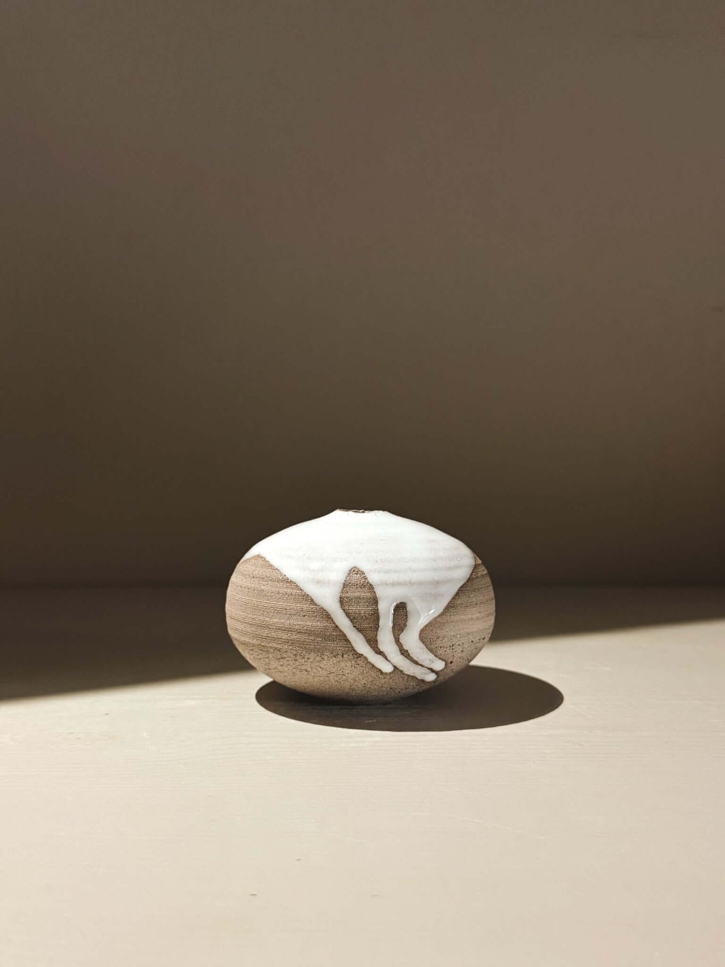 Orb Vase – Yuki Ash #11, a japanese handmade ceramic orb vase with unique glaze patterns.
