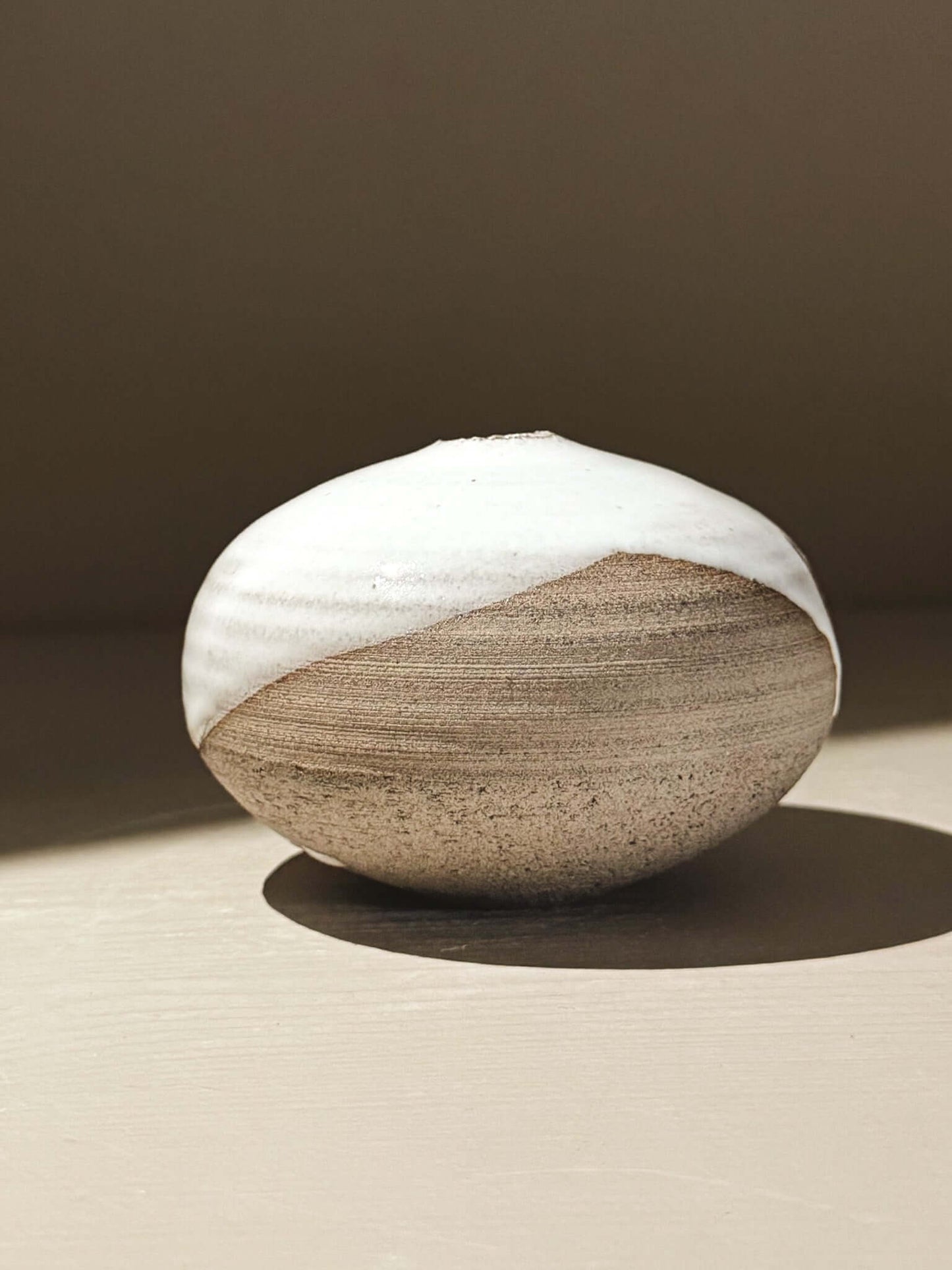 Orb Vase – Yuki Ash #11, Japanese handmade ceramic orb vase with unique glaze patterns and soft spherical form.