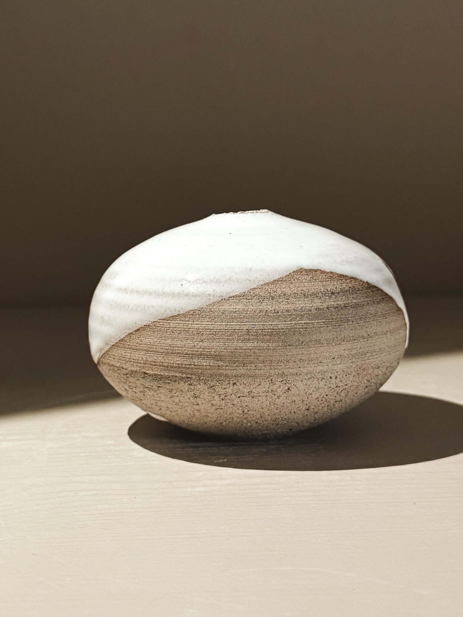 Orb Vase – Yuki Ash #11, Japanese handmade ceramic orb vase with unique glaze patterns and soft spherical form.