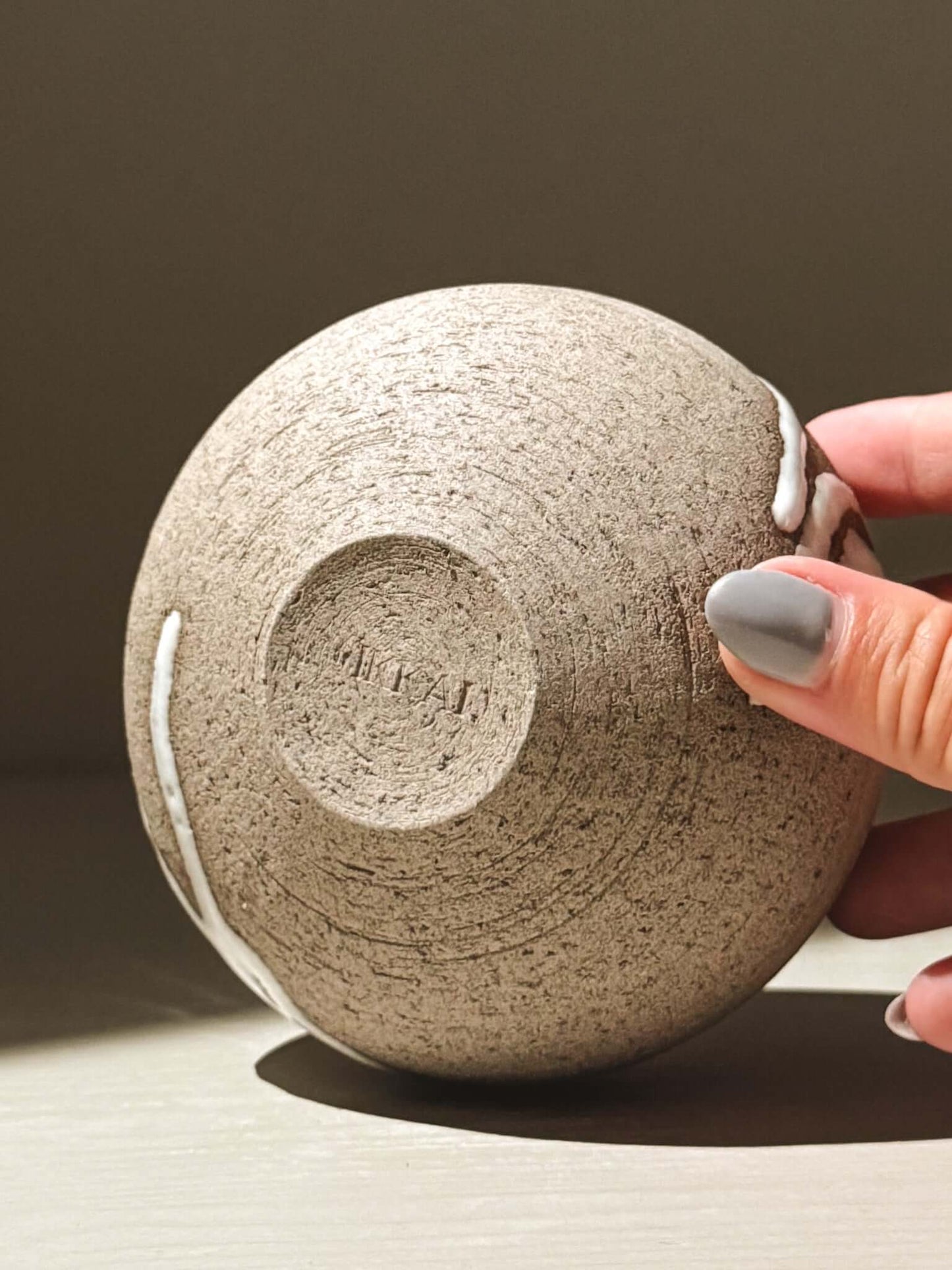 Orb Vase – Yuki Ash #11, a unique Japanese handmade ceramic orb vase showcasing natural glaze movement.