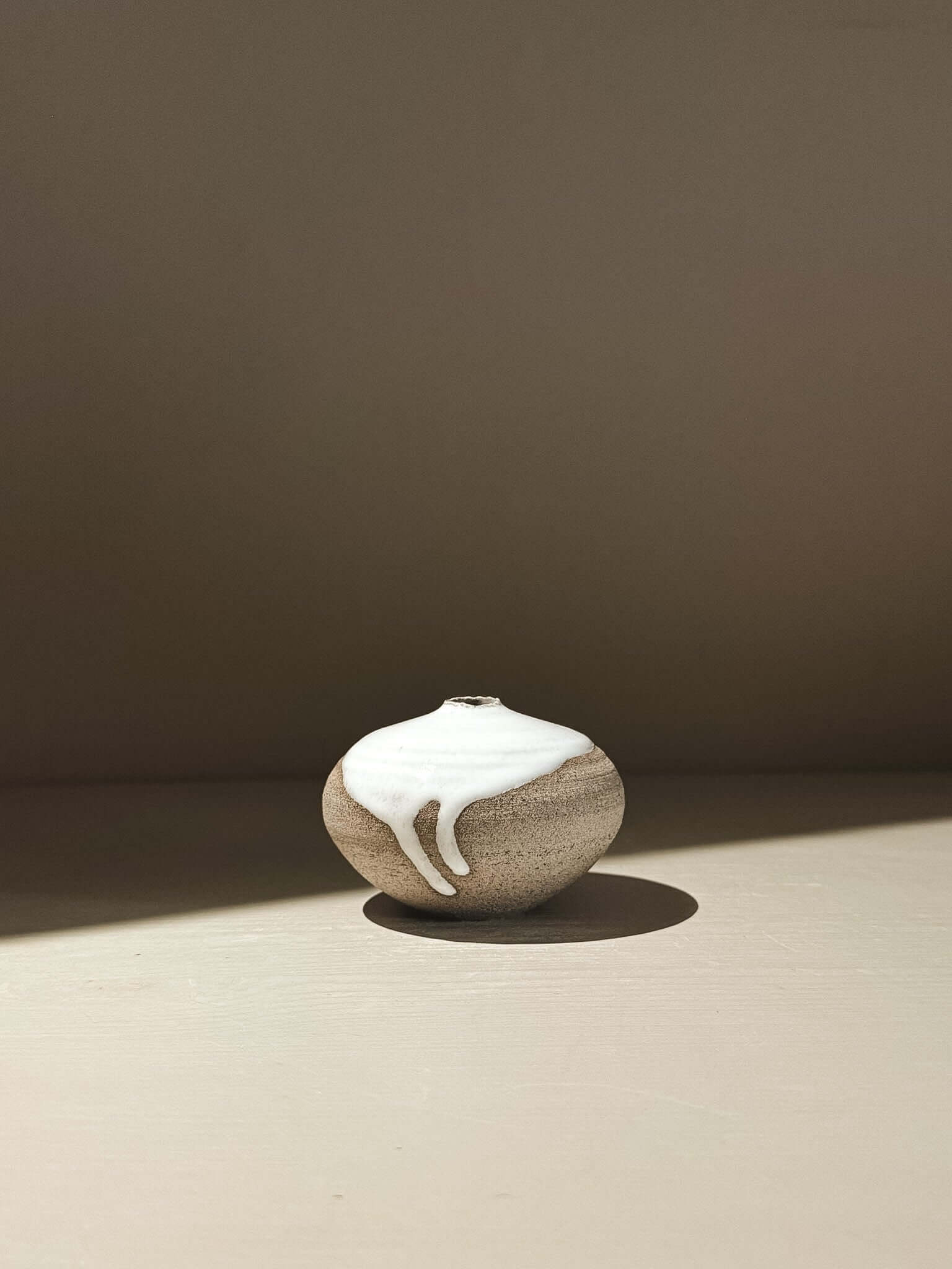 Orb Vase – Yuki Ash #12, a unique handmade ceramic orb vase with organic glaze patterns.