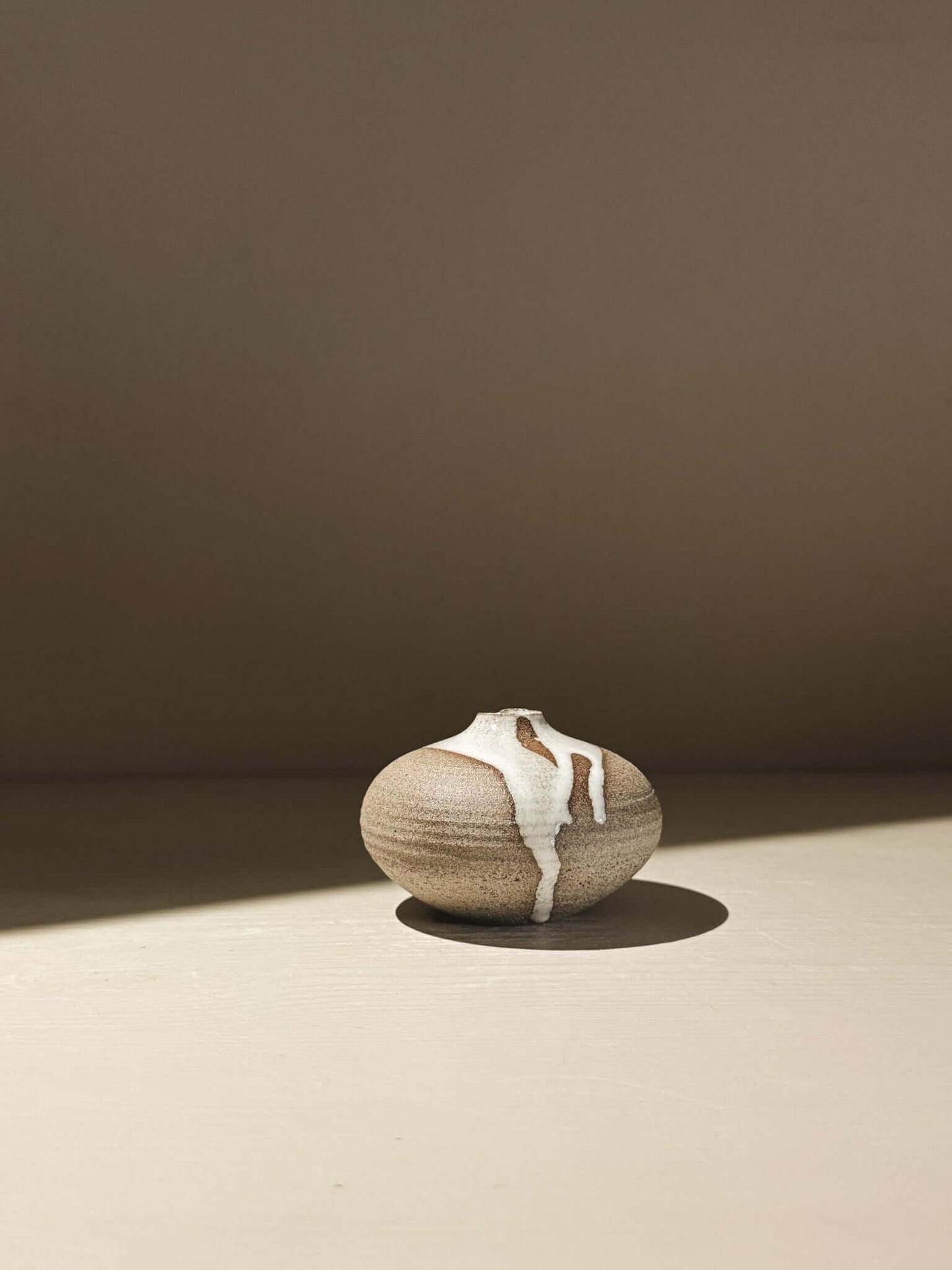 Handmade ceramic Japanese orb vase – Yuki Ash #13 with unique glaze movement and soft spherical form.
